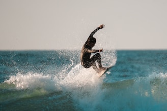 Surfer carves through a wave.