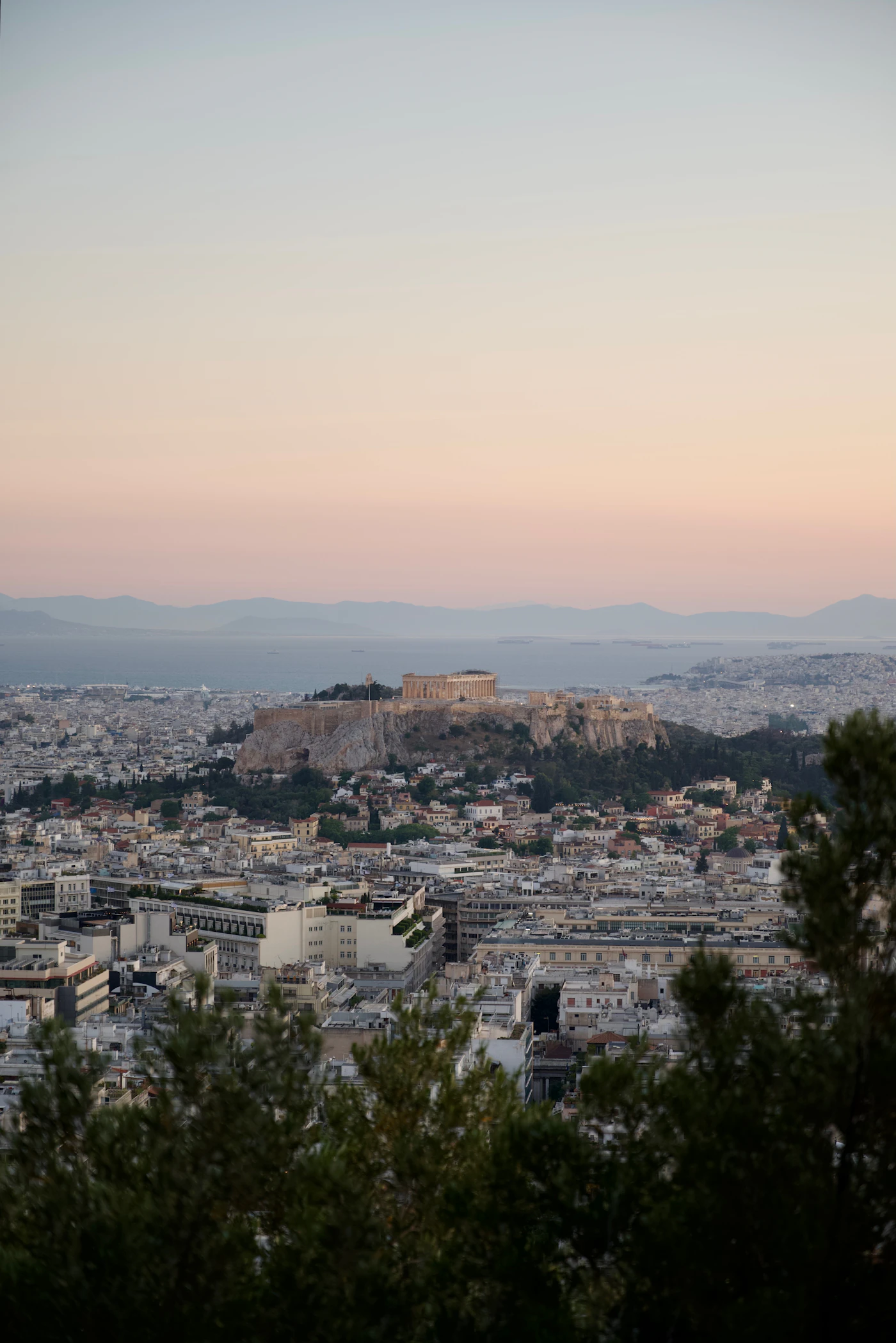 Low Athens skyline at sunset with the Acropolis standing out
