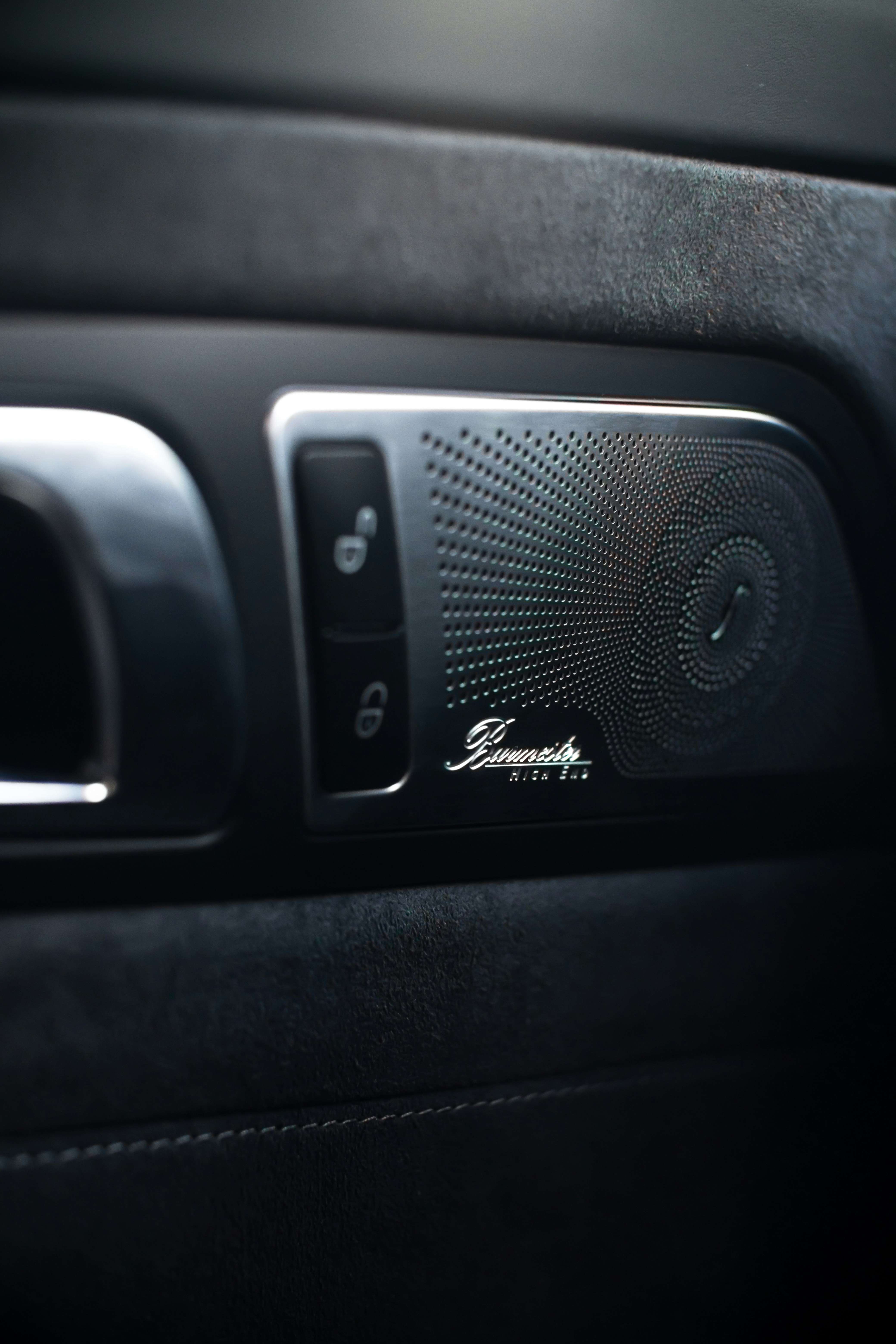 A close-up of a car's door panel speaker.