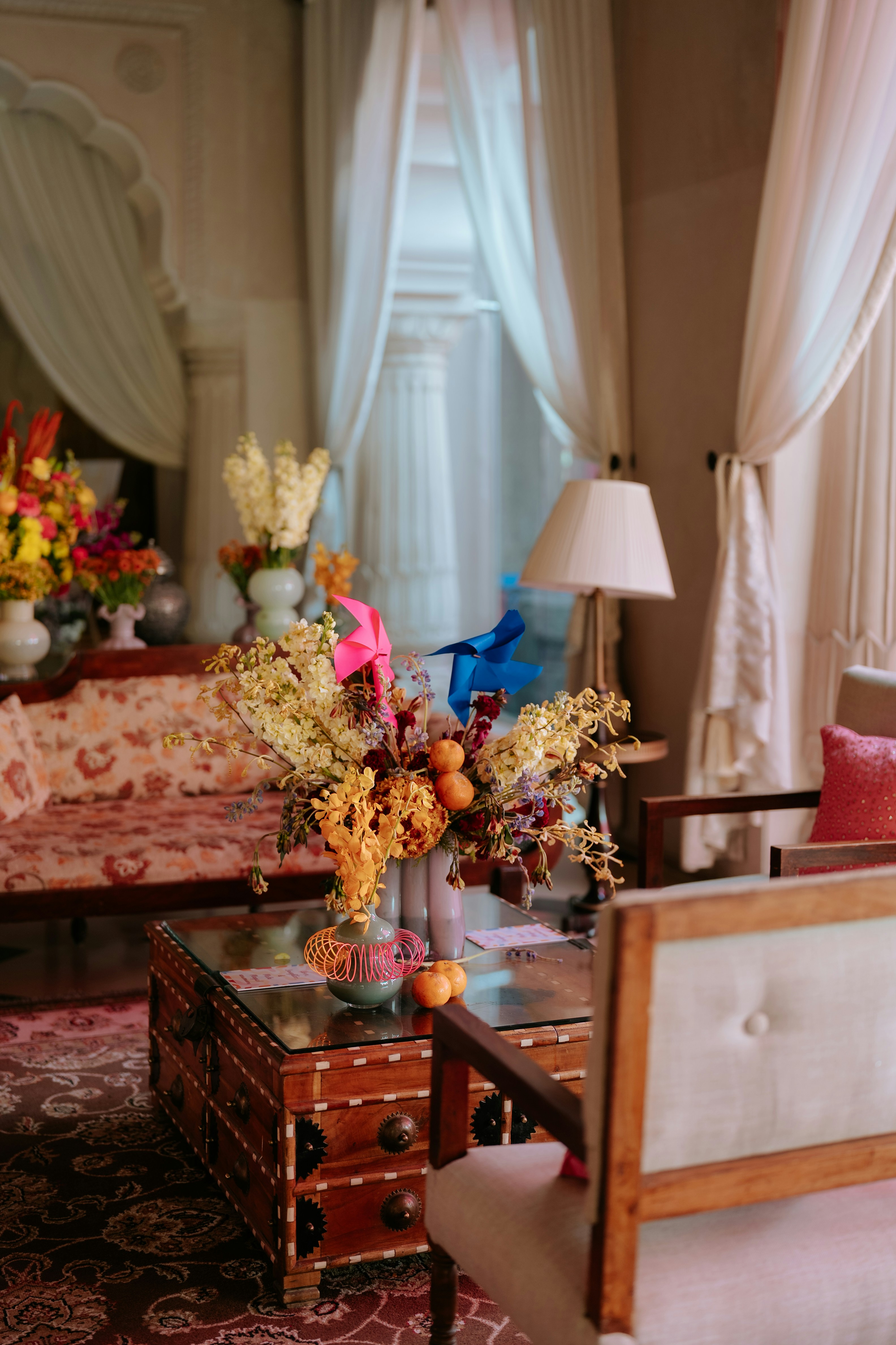 A room is decorated with flowers and furniture.