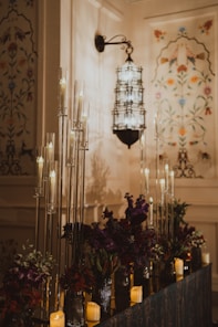 Elegant candles and flowers decorate a room.
