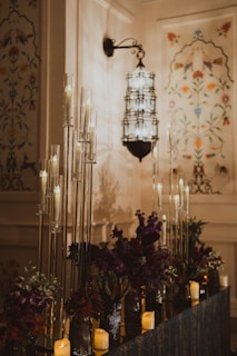 Elegant candles and flowers decorate a room.