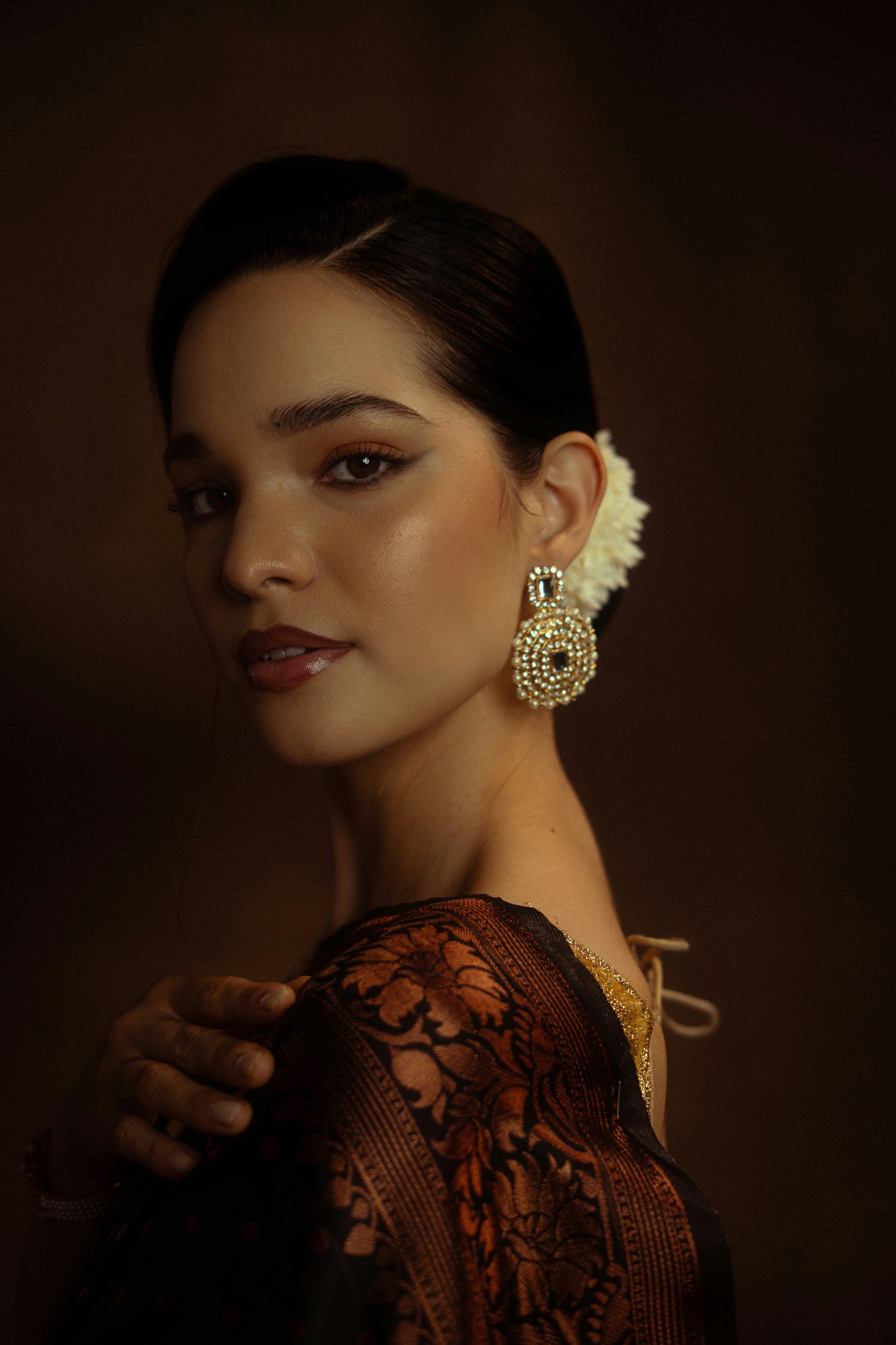 Elegante Frau mit einem schönen Ohrring und Sari.