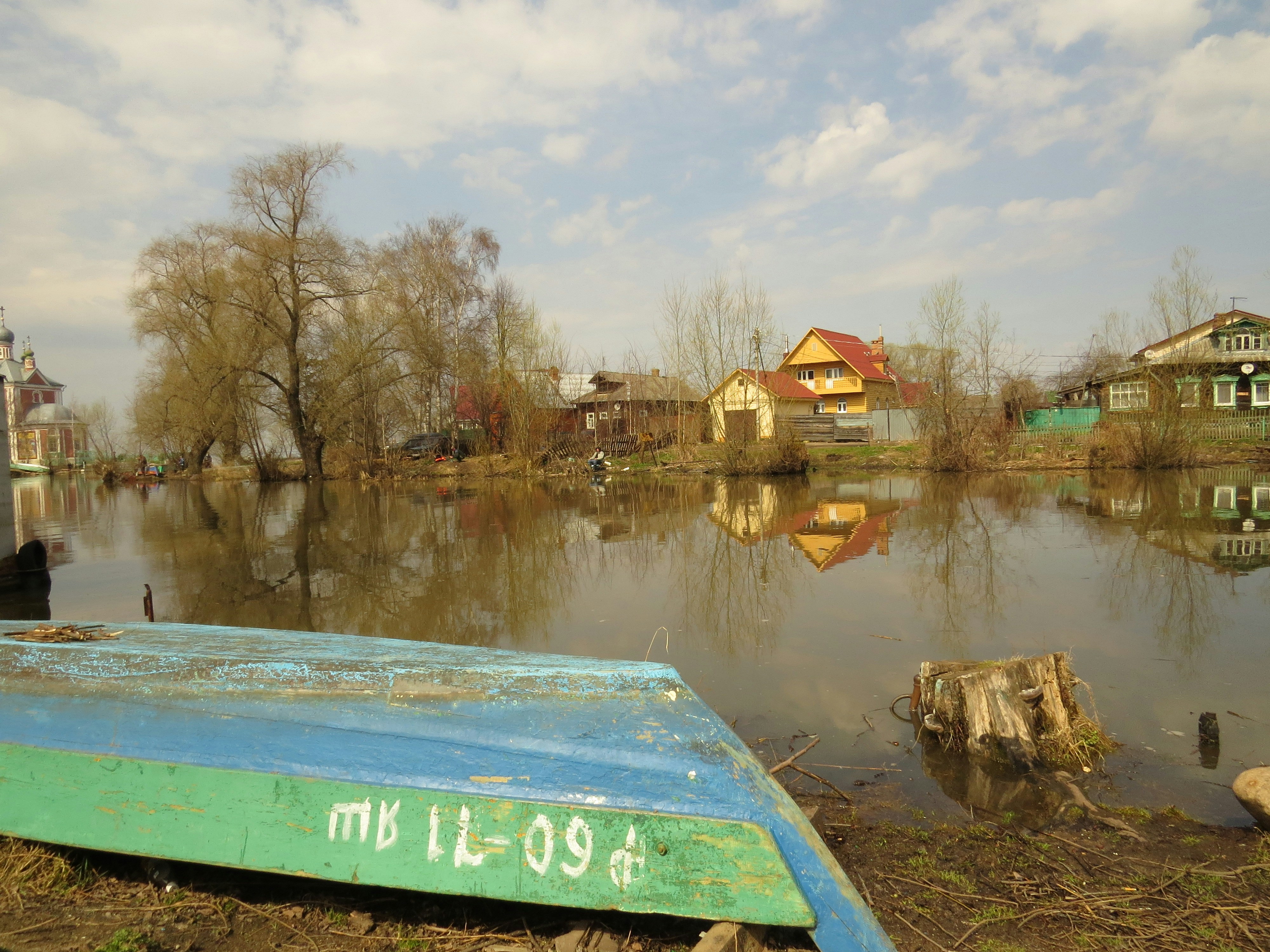 Flooded village reflects in the water.