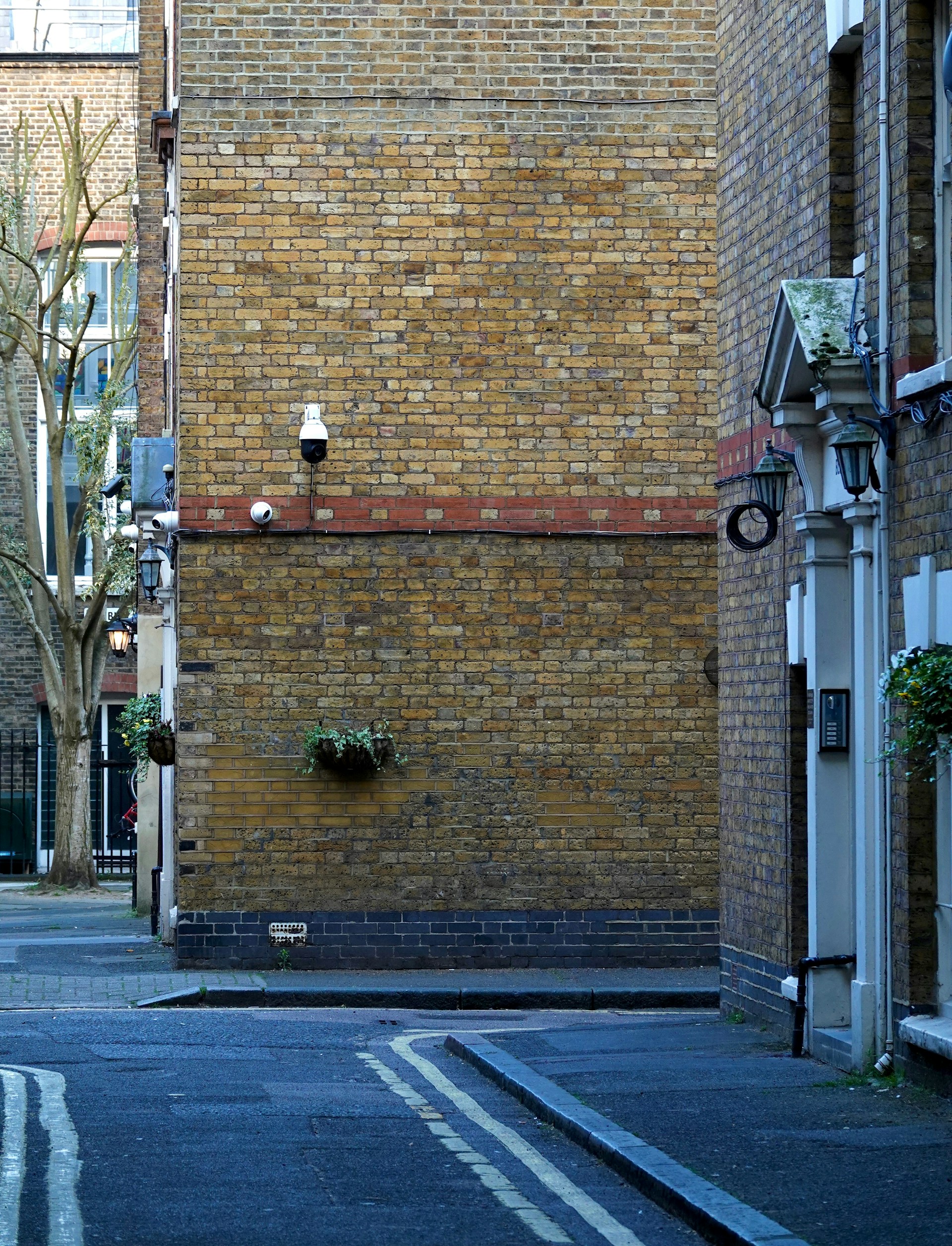 A narrow street with brick buildings.