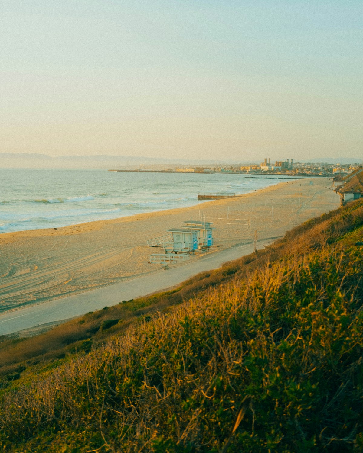 A coastal view of the beach in soft light