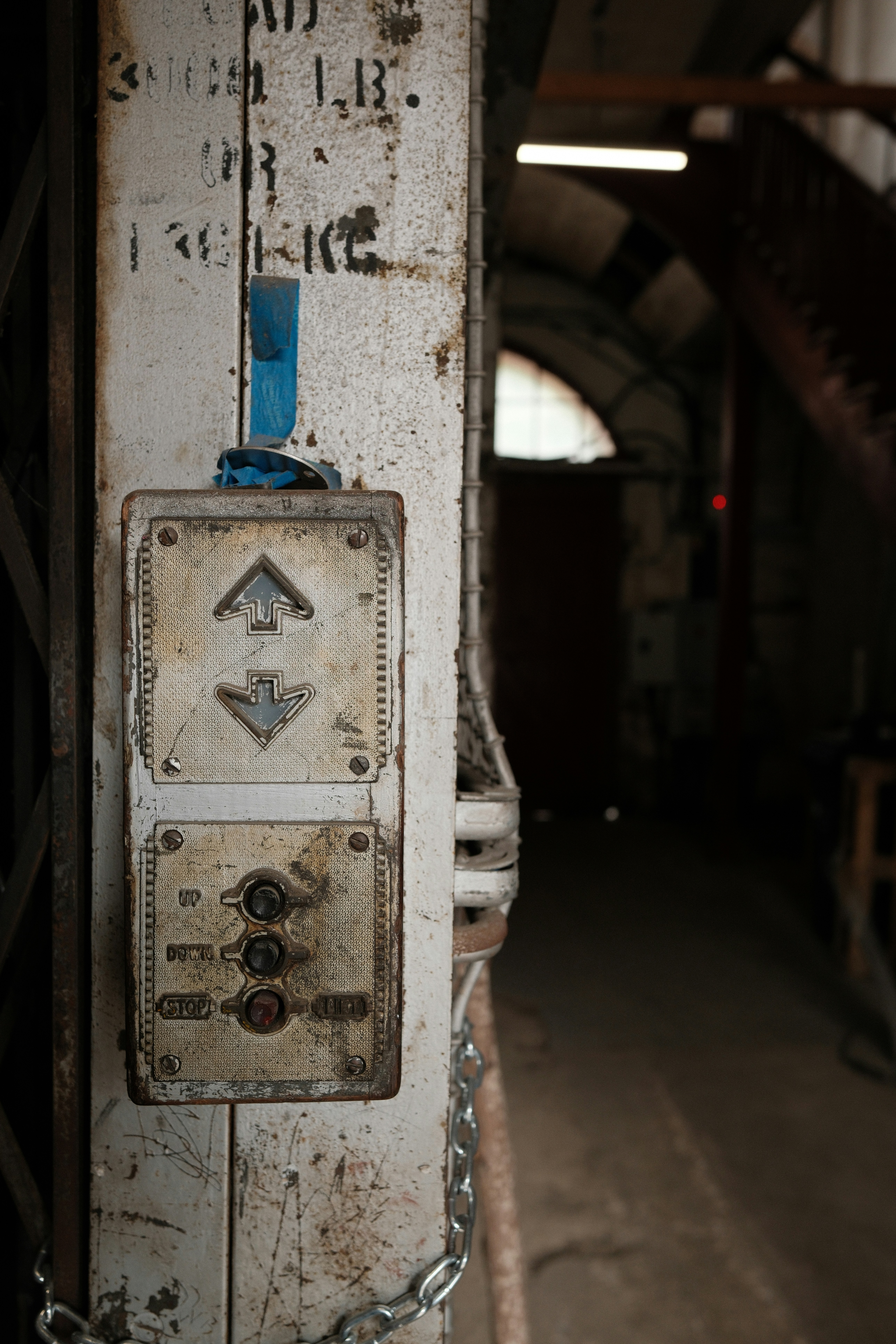 Old elevator control panel with up and down buttons.