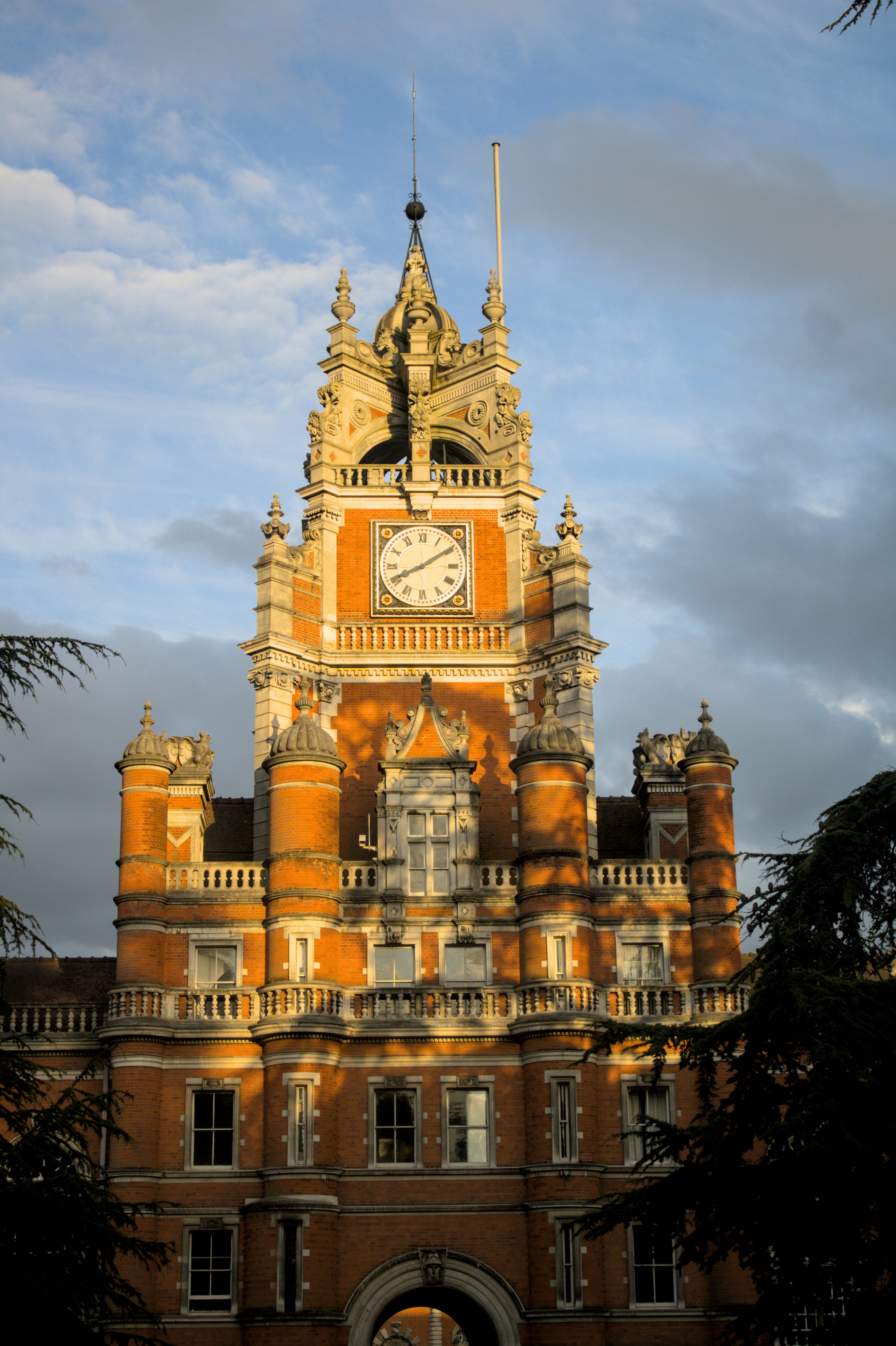 A beautiful, classic clock tower lit by sunlight.