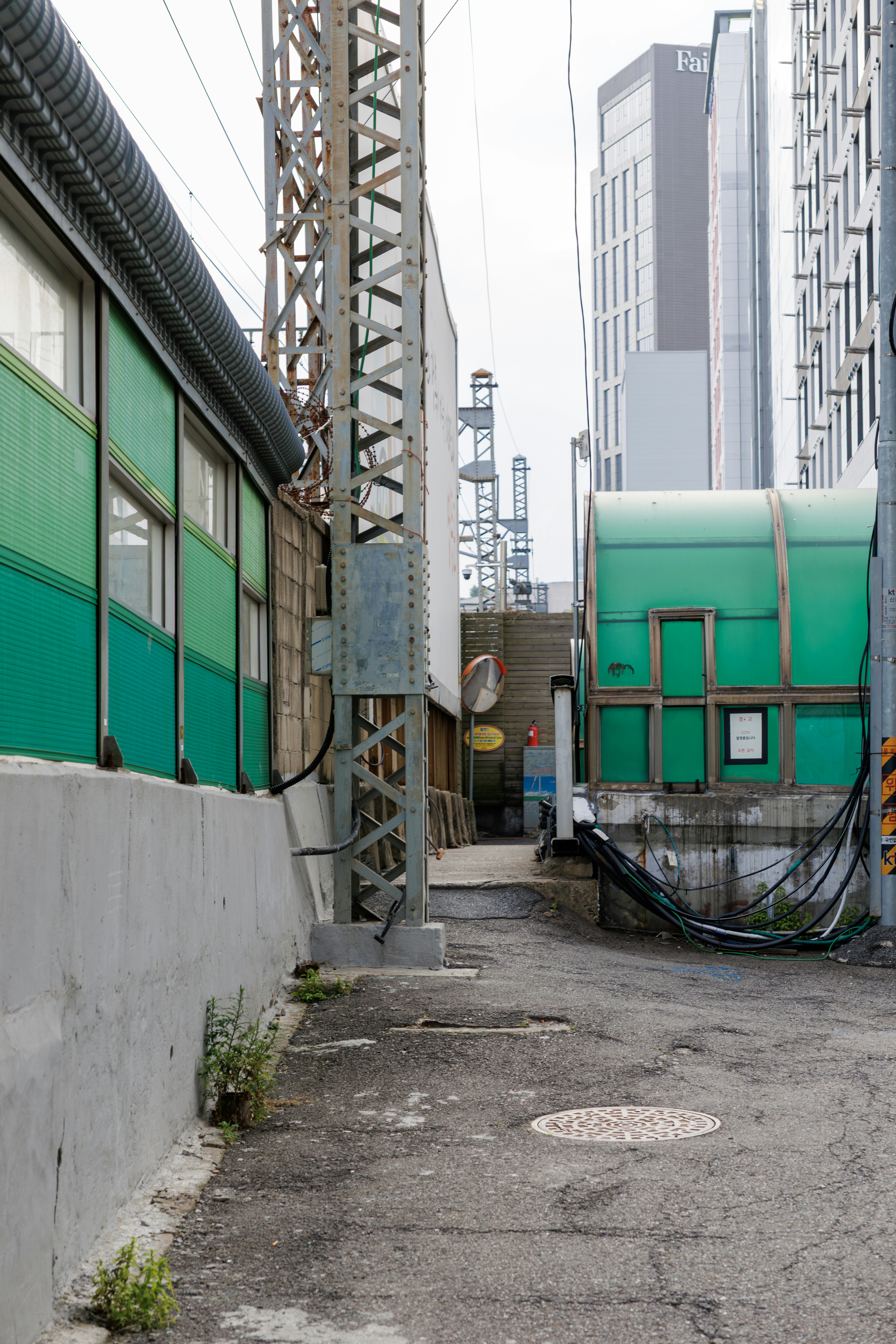 A narrow alleyway leads towards distant buildings.
