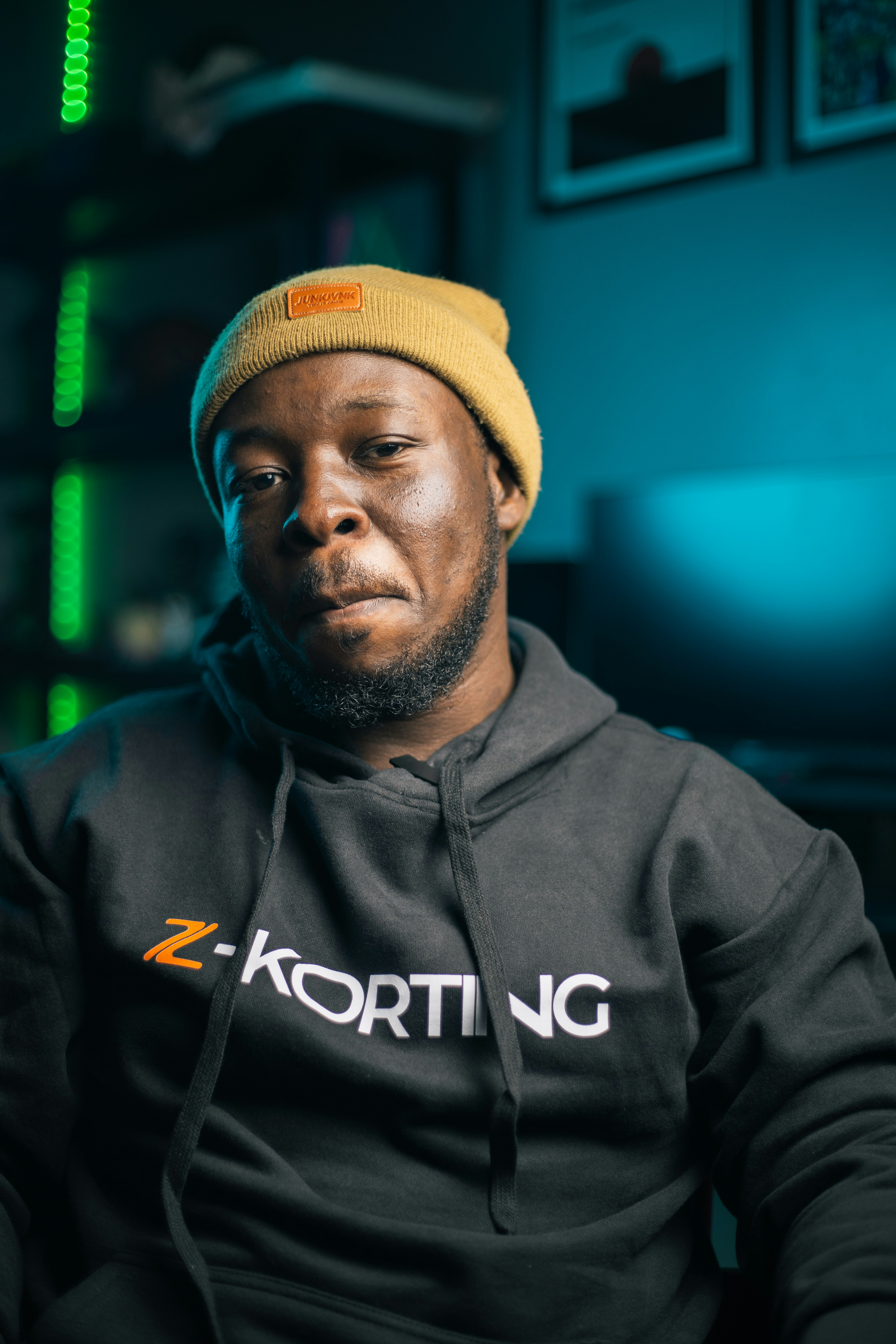 Man in a beanie and hoodie, looking at the camera.