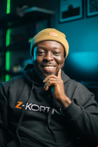 A man smiles while looking at the camera