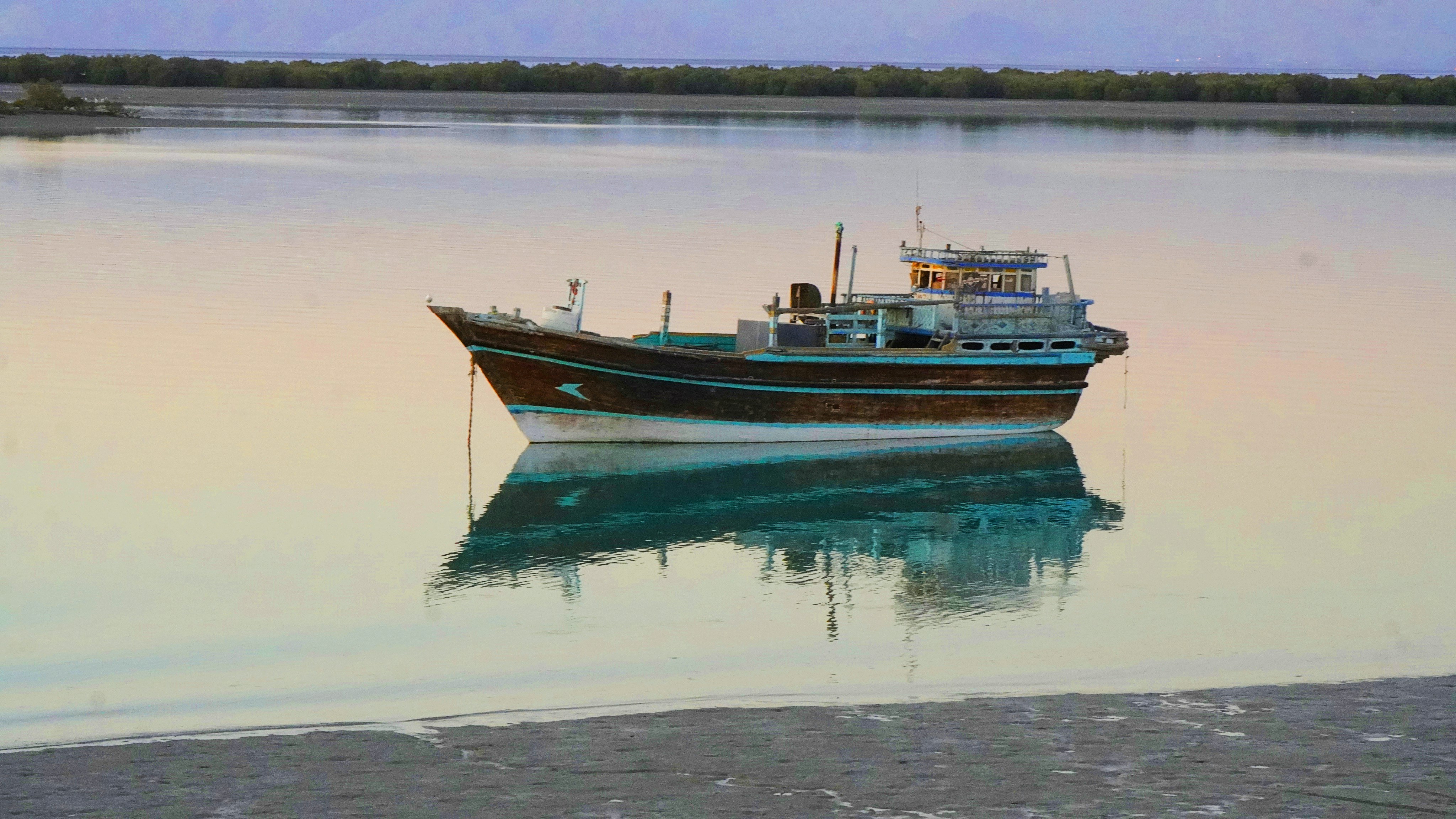 A boat floats on a calm lake.
