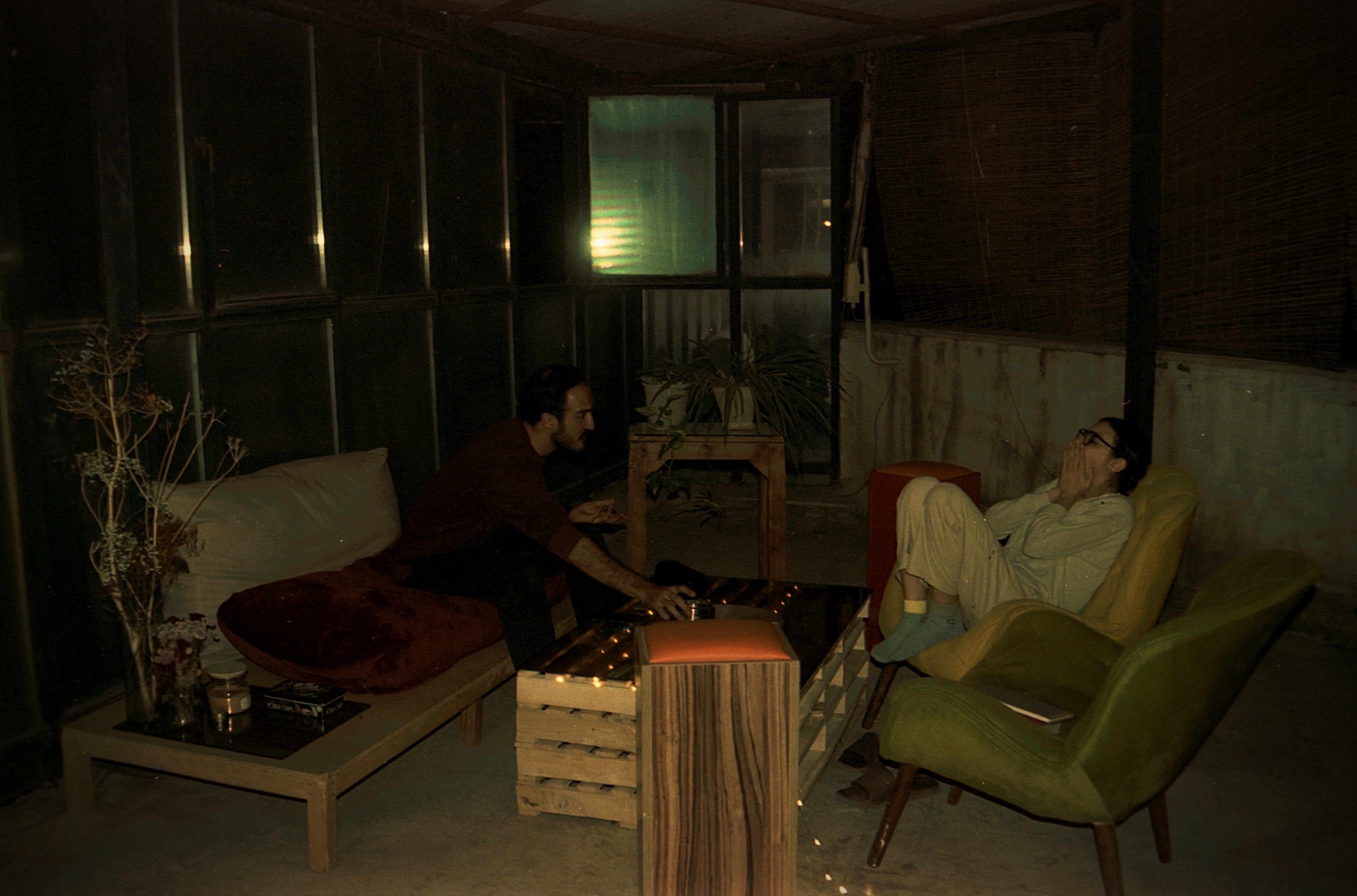 Friends relax in an outdoor lounge area.