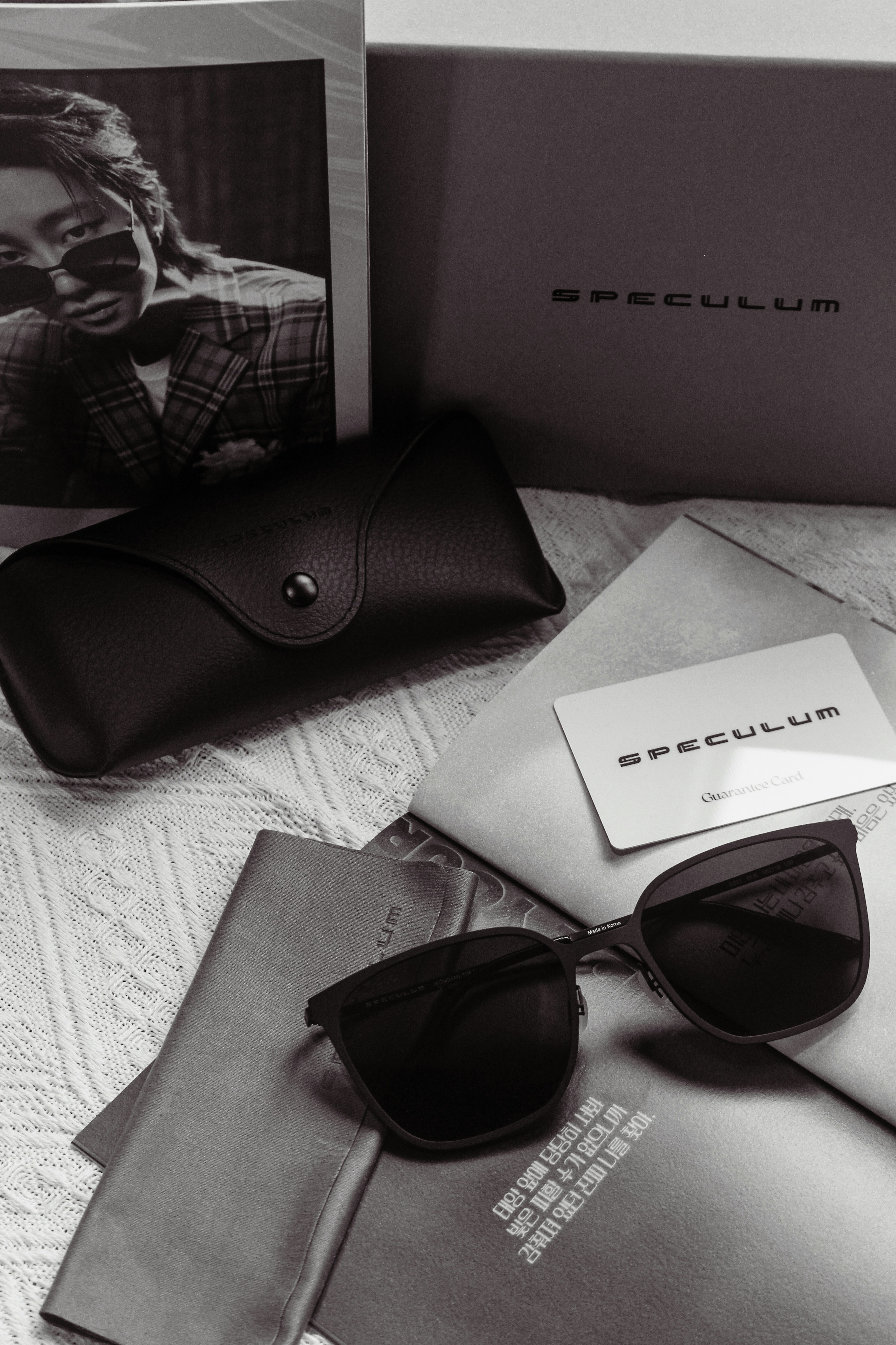 Sunglasses and accessories are artfully arranged.