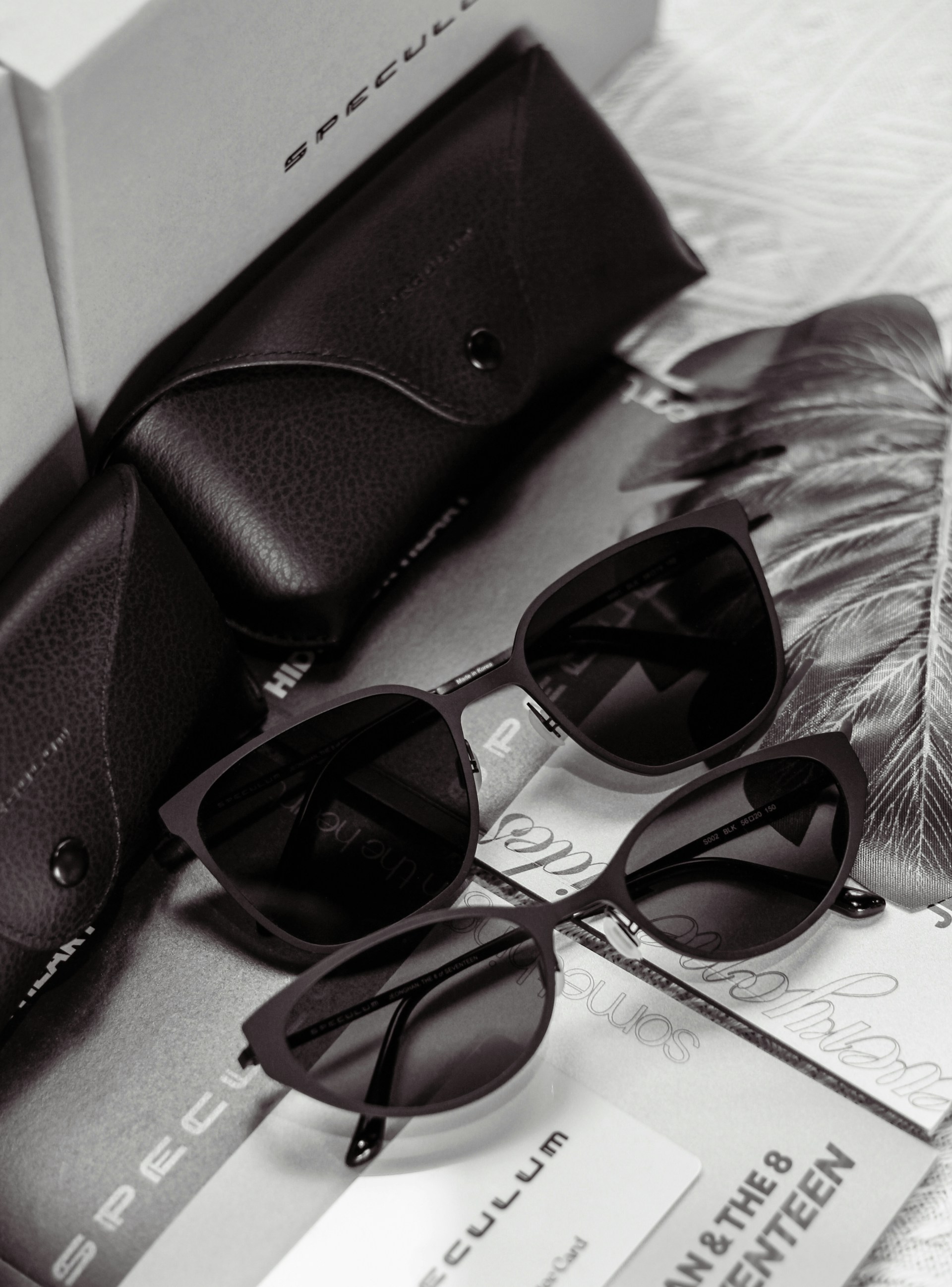 Sunglasses and their cases are neatly arranged.