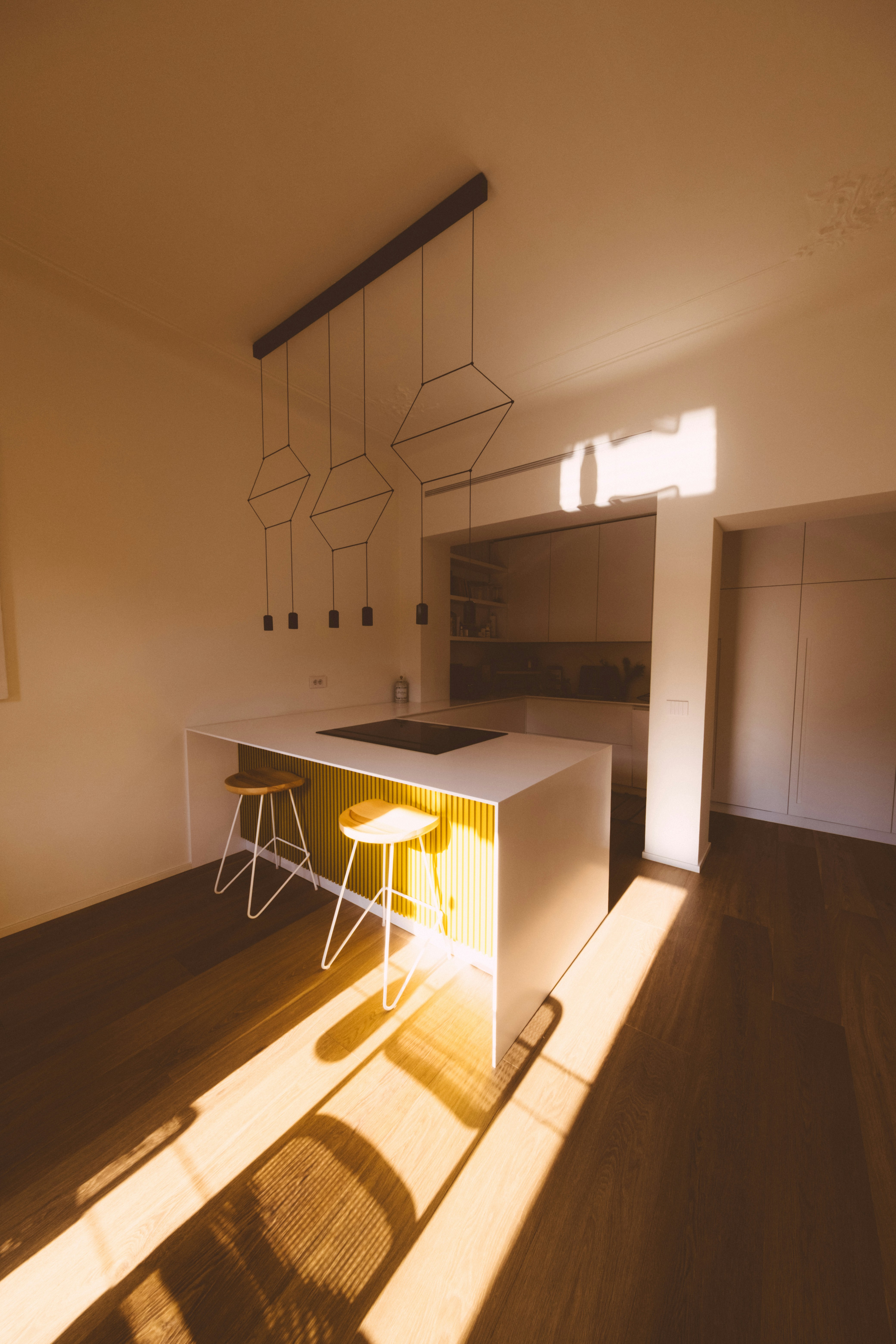 A modern kitchen island is illuminated by sunlight.
