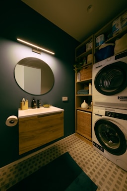 A modern laundry room with a dark, stylish design.