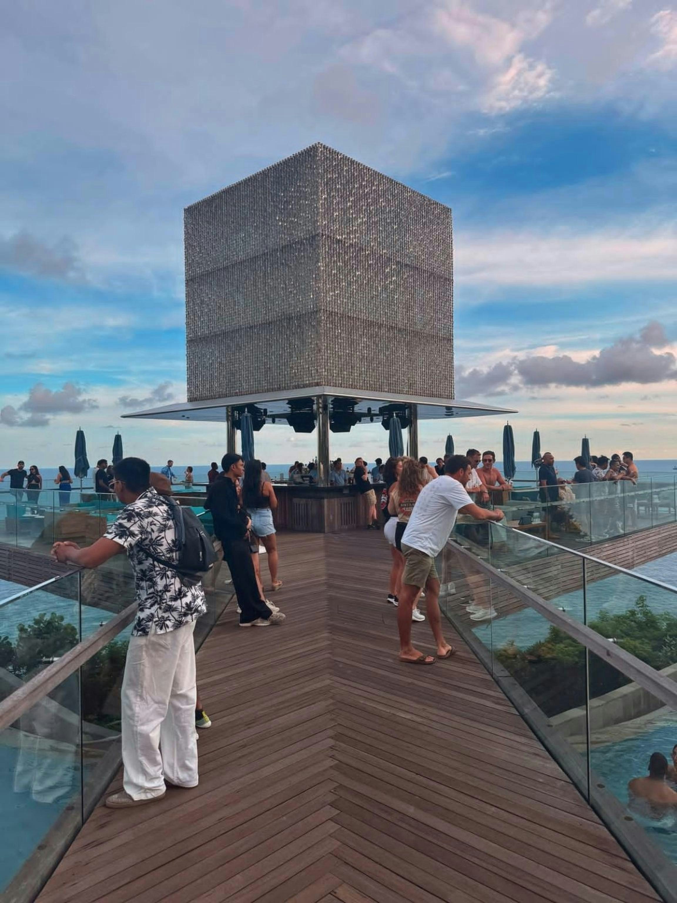 People enjoy drinks at an outdoor bar.