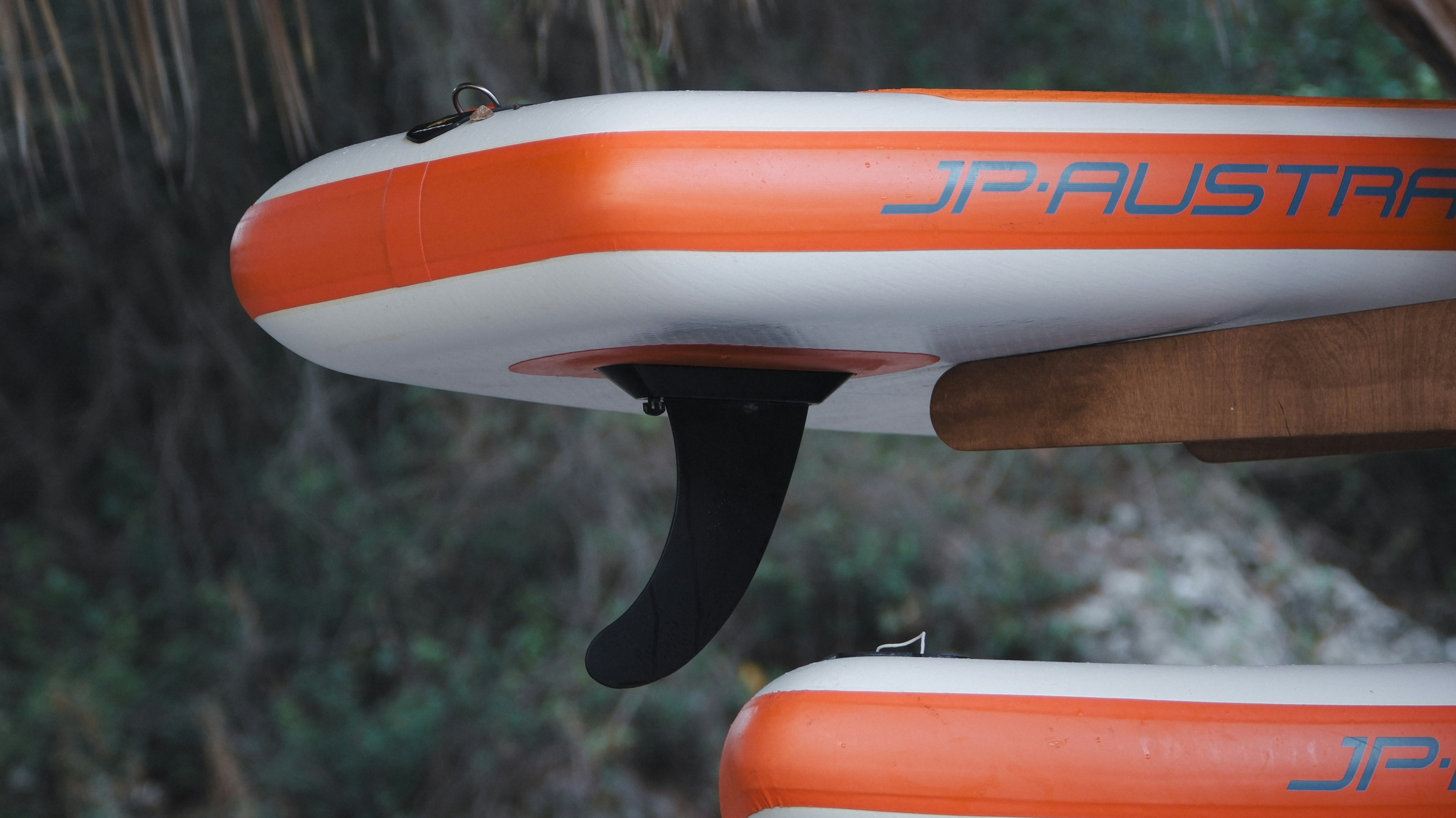 A sup board fin is shown up close.