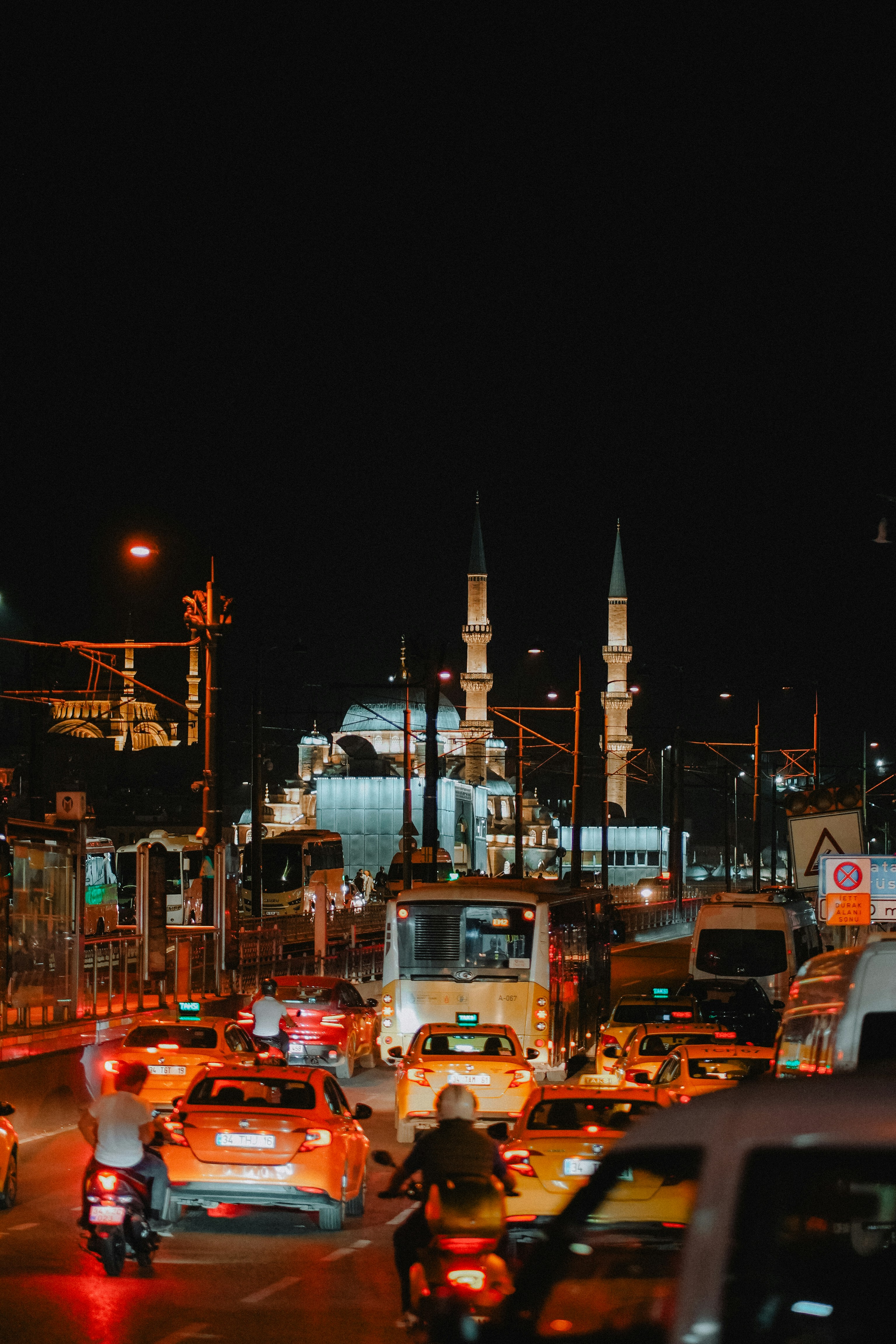 Traffic jams illuminate a mosque at night.