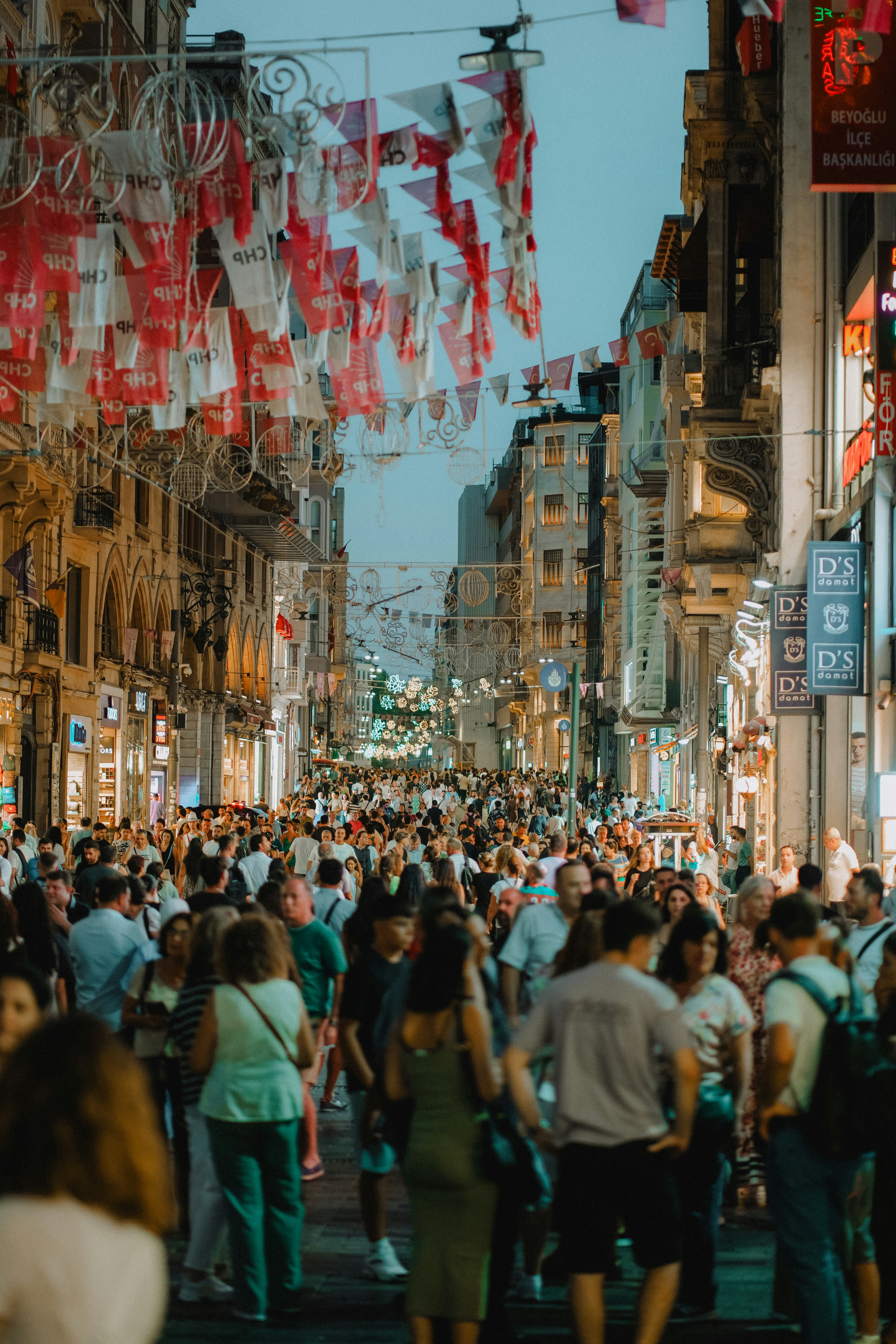 A crowded street with decorations and buildings.