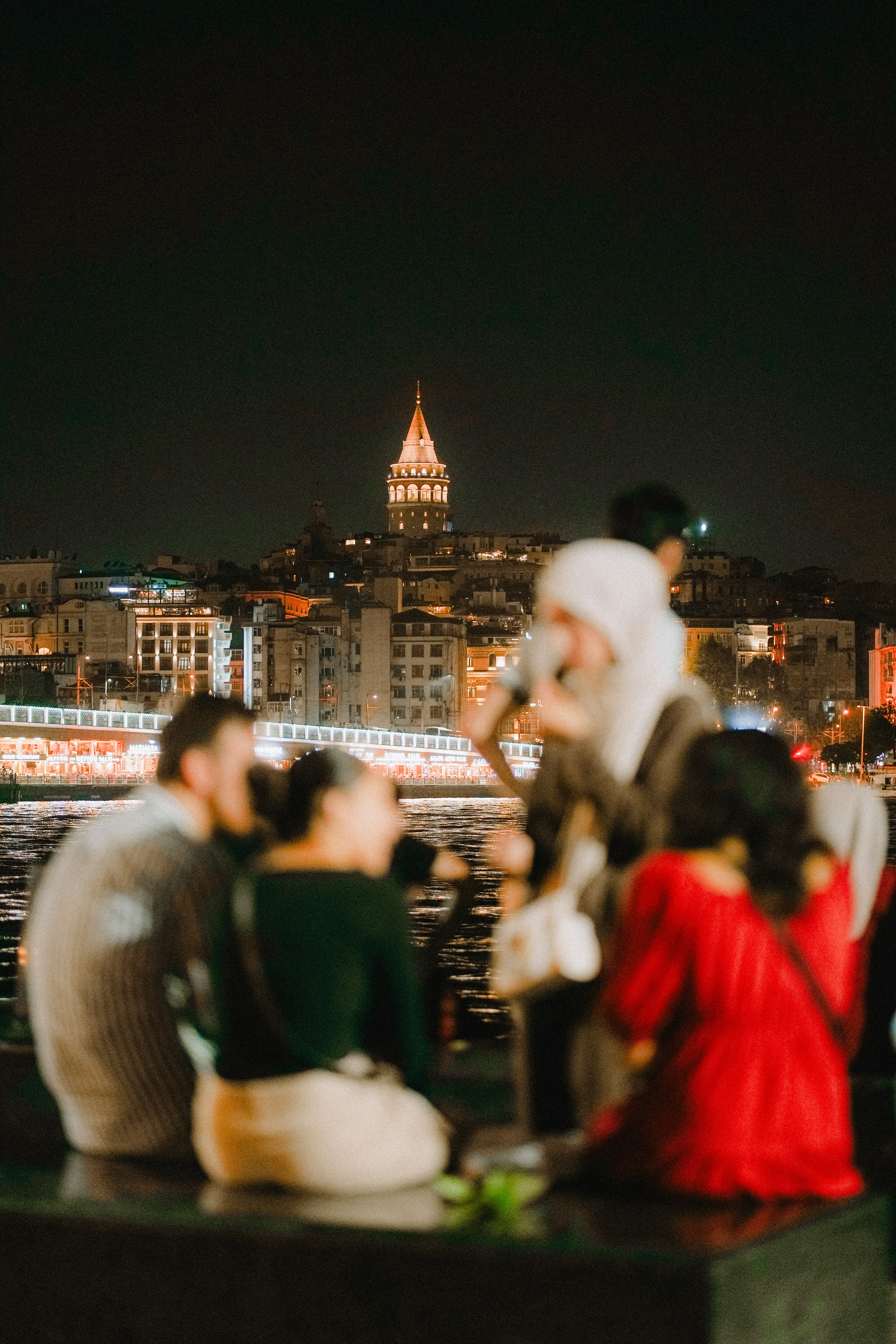 People admire the city skyline at night.