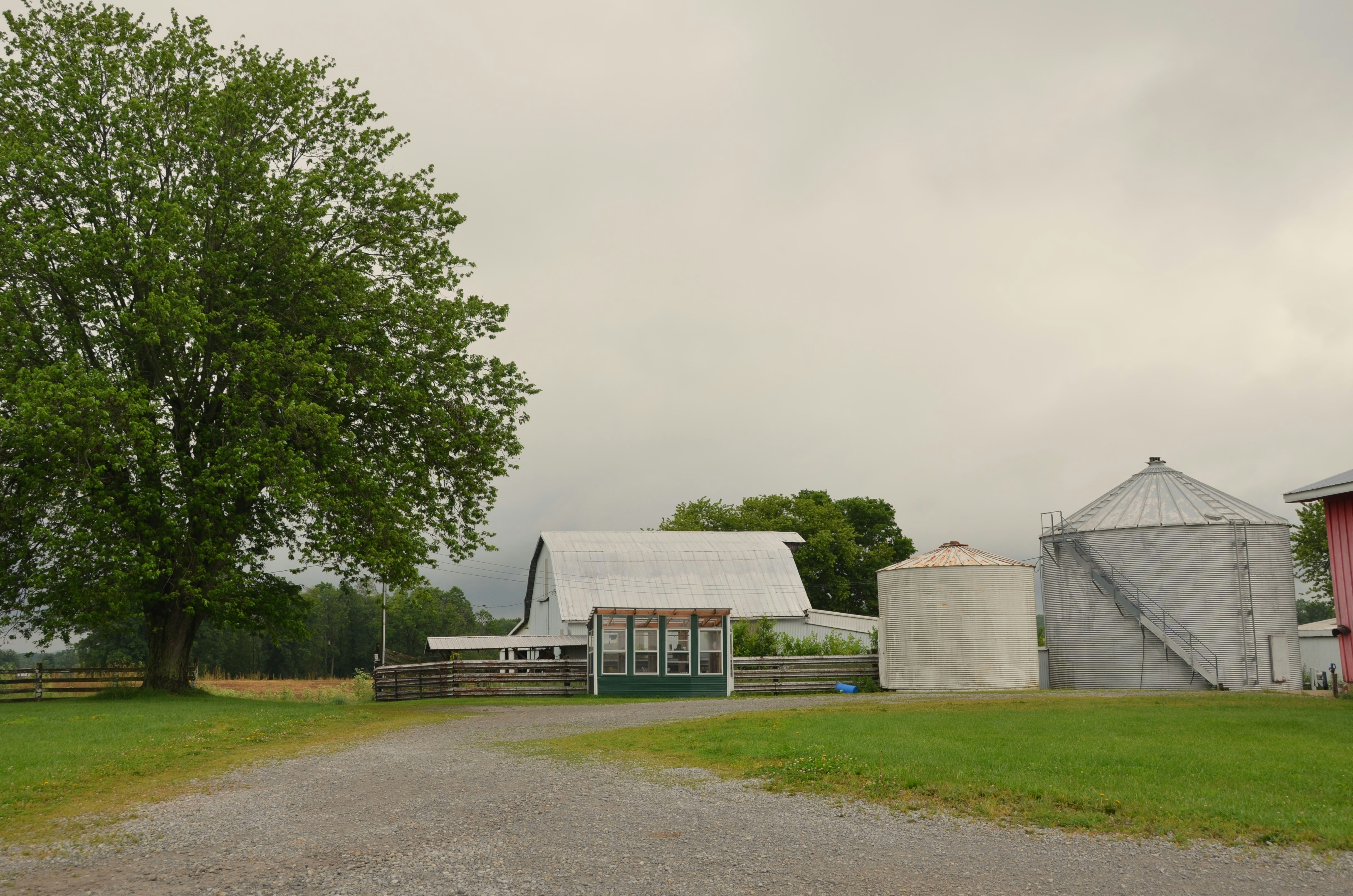 A farm with a barn and silos.