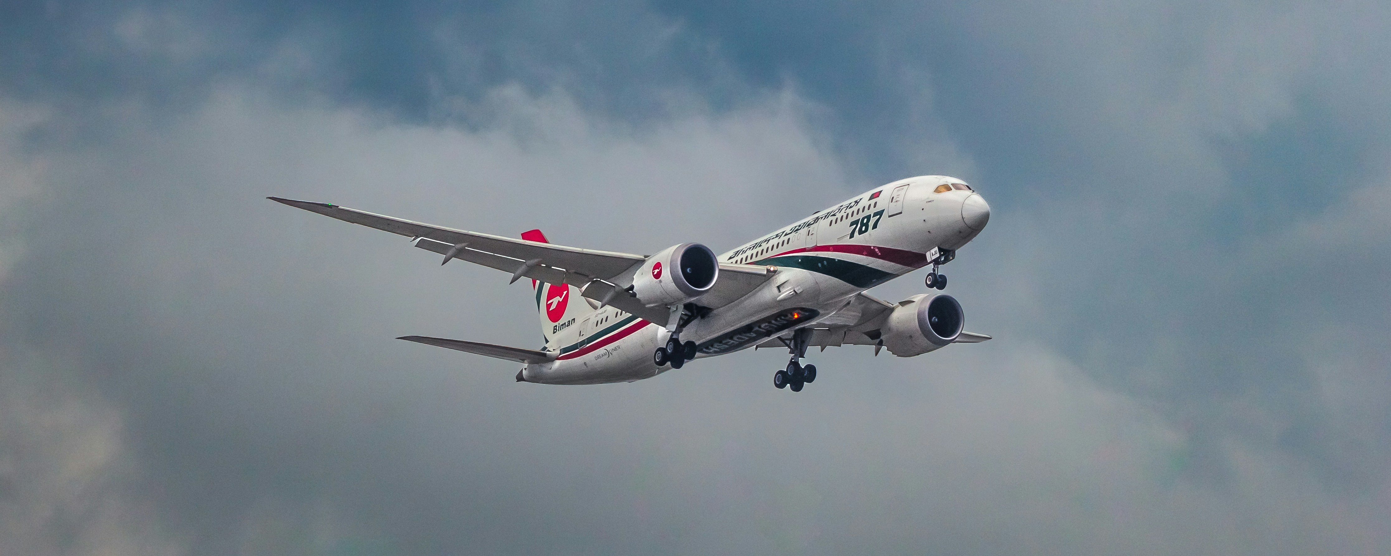 A commercial airplane ascends into a cloudy sky.