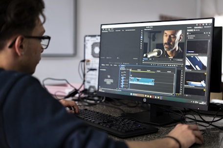 A person edits video on a computer.