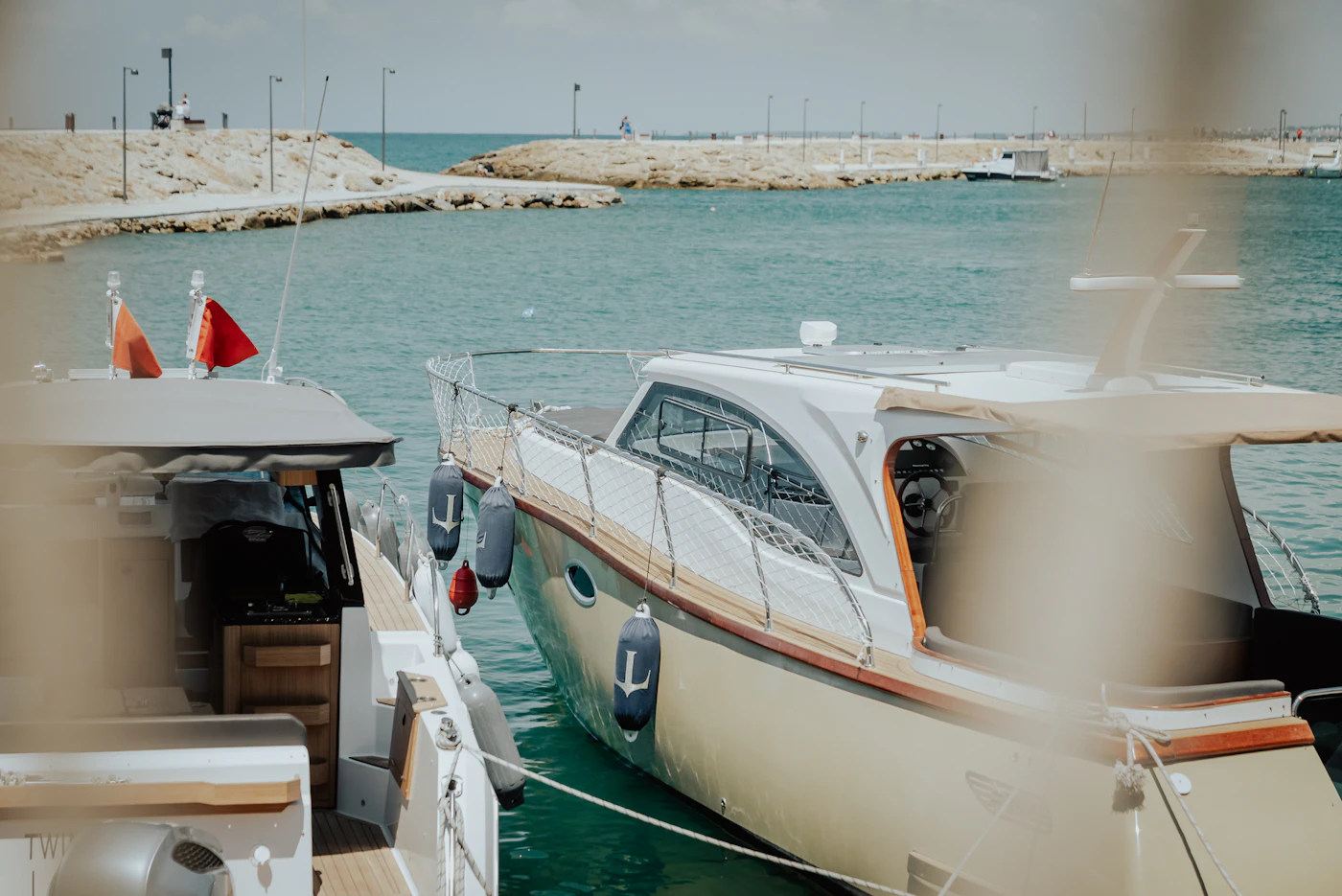 Yachts resting in a clear Mediterranean harbor