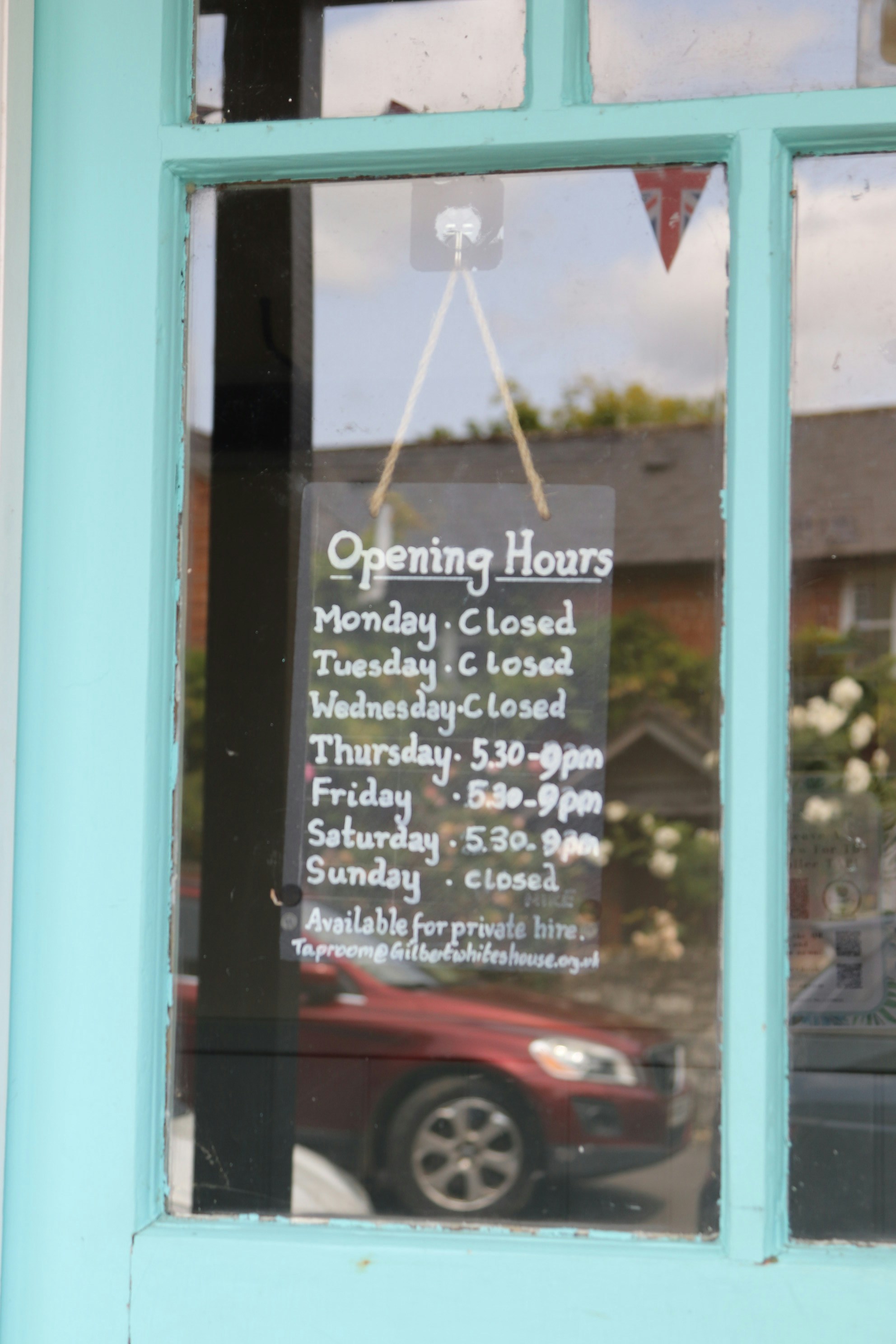 A Sign With Store Hours