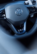 The volkswagen steering wheel is shown up close.