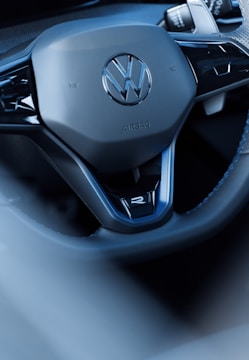 The volkswagen steering wheel is shown up close.