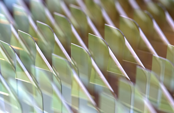 A 3D render of iridescent liquid glass file icons in a row. Adam Gethin, Unsplash