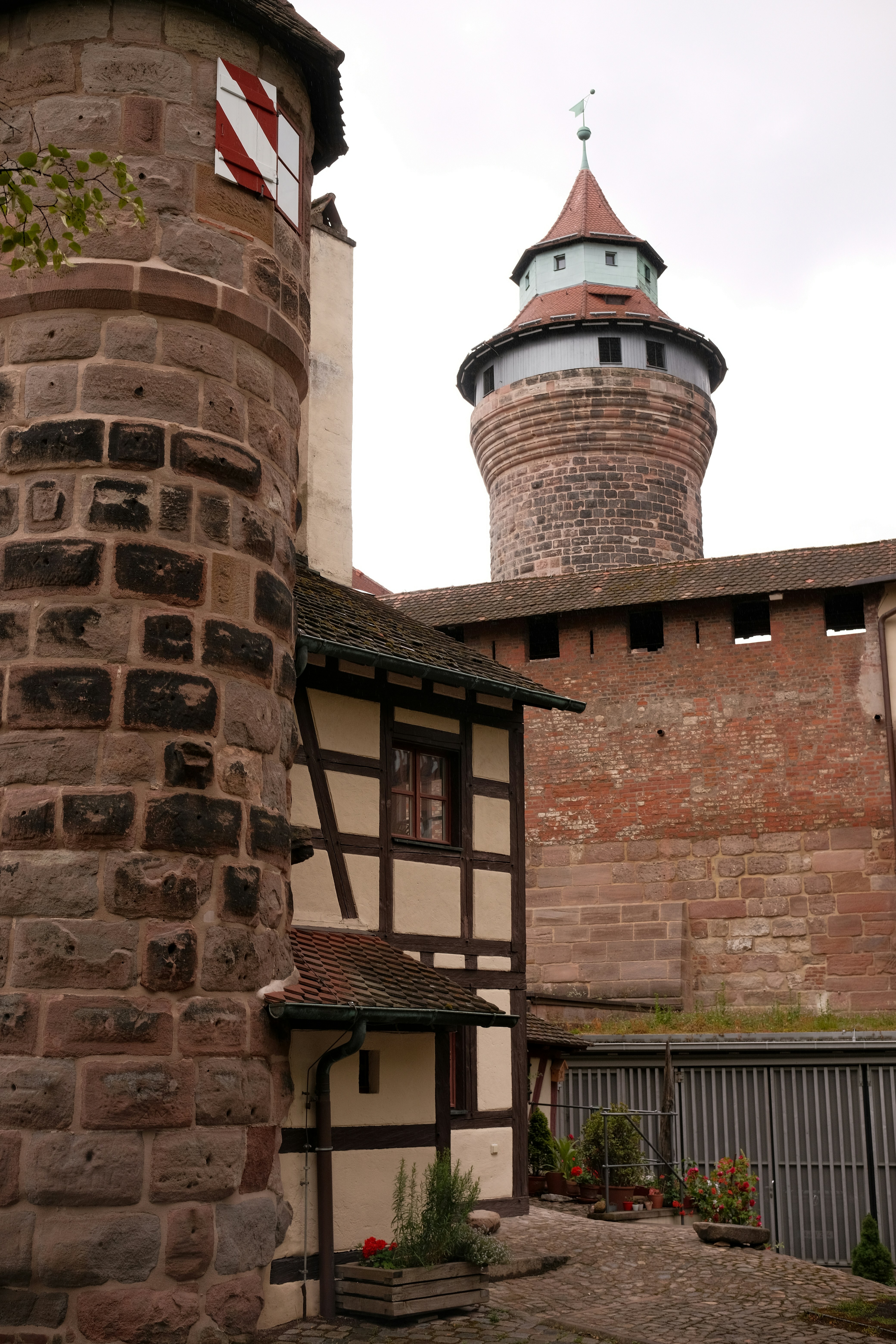 Historic Nuremberg architecture showcasing a medieval tower and half-timbered house in Nuremberg castle.
