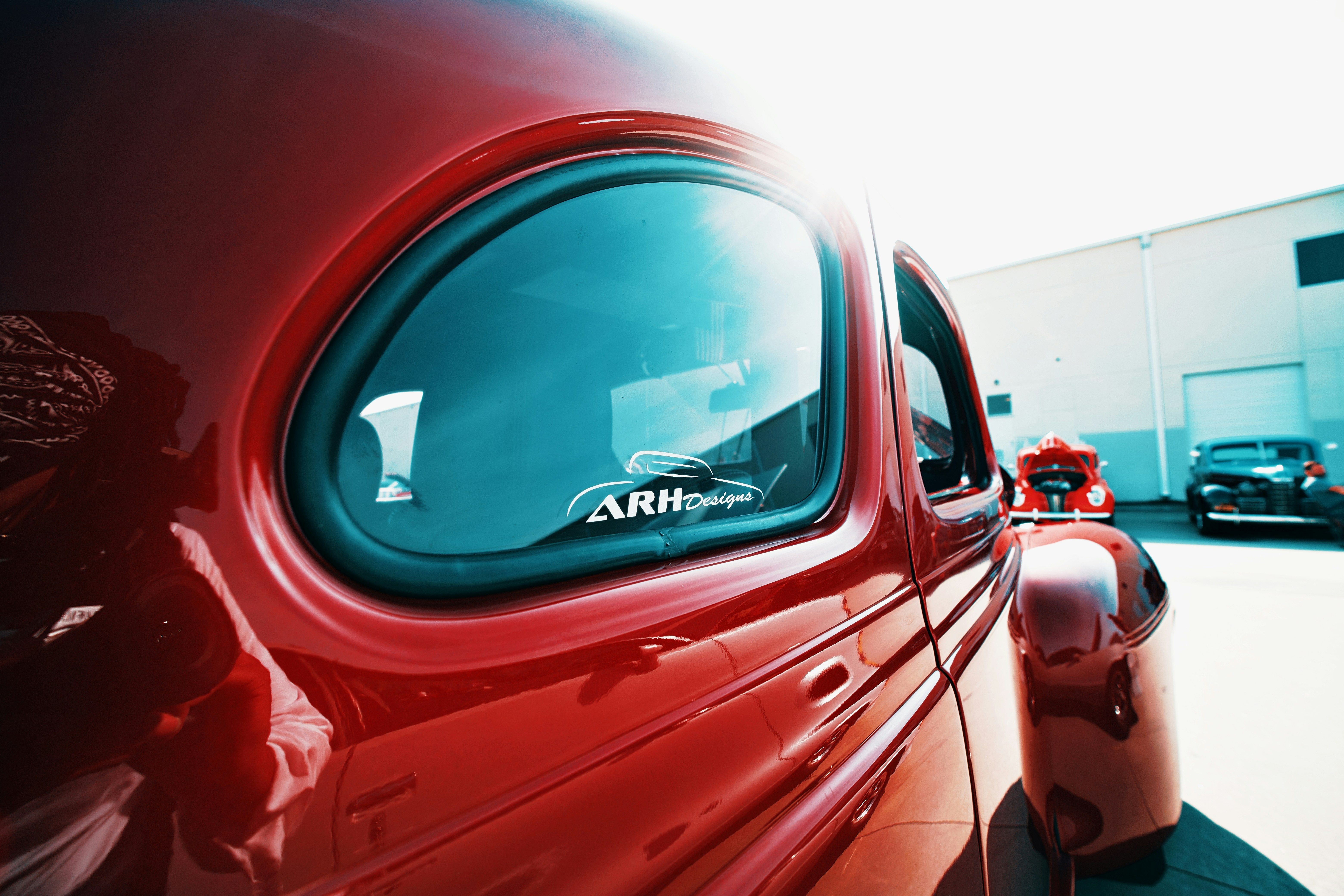 Red classic car detail, sunny day.