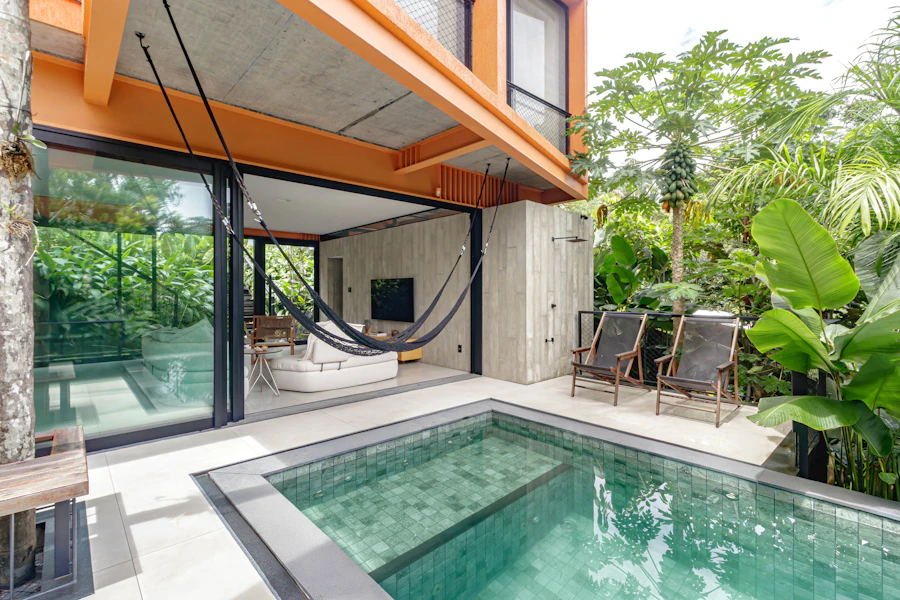 Modern home with a pool and sunny outdoor seating