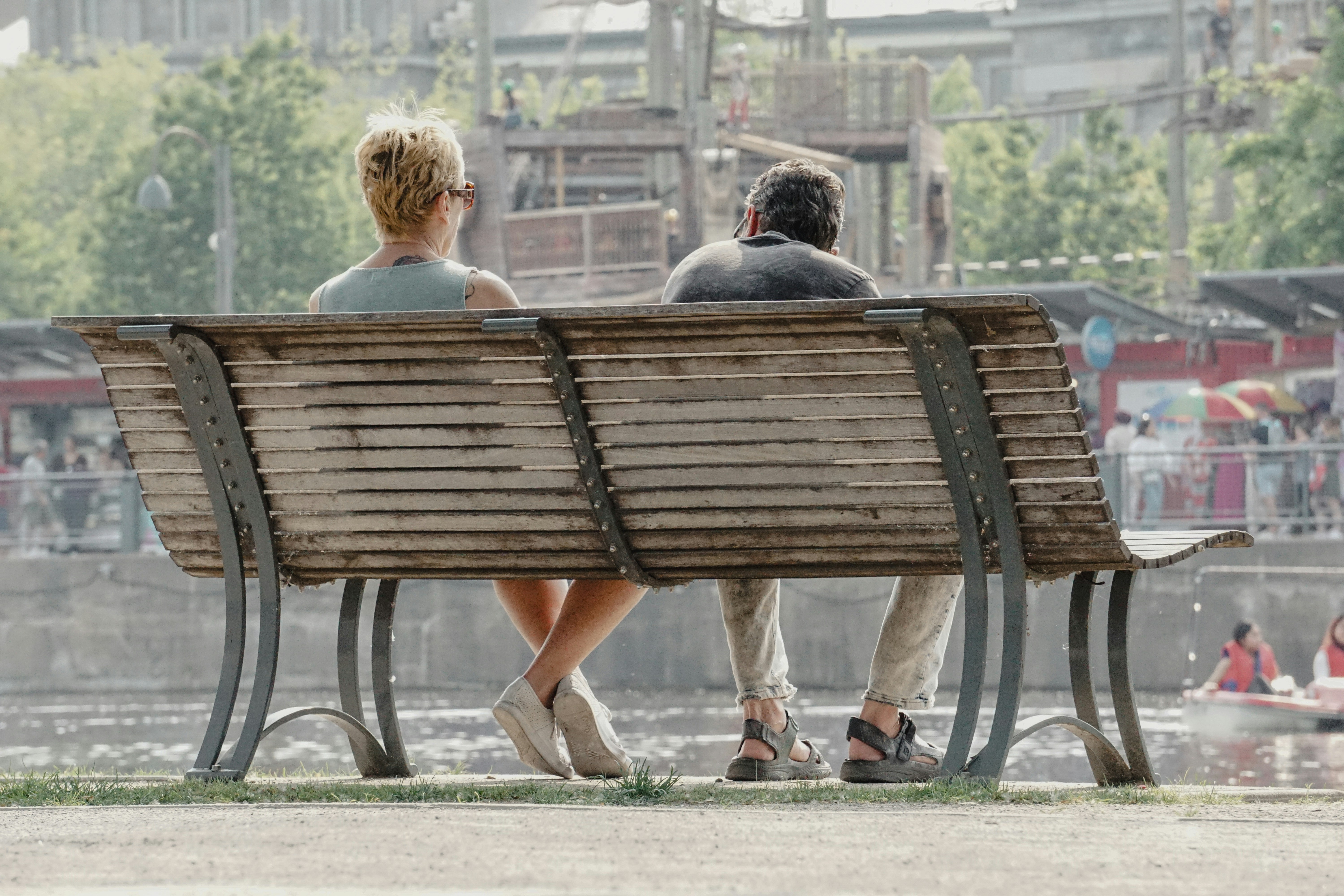 A couple sits on a bench, enjoying the view.