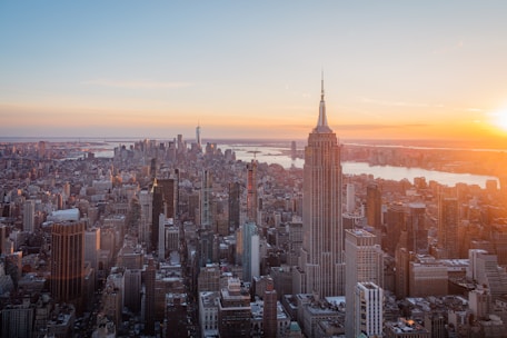 The empire state building shines at sunset in nyc.