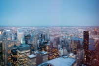 Nighttime cityscape features many illuminated skyscrapers.