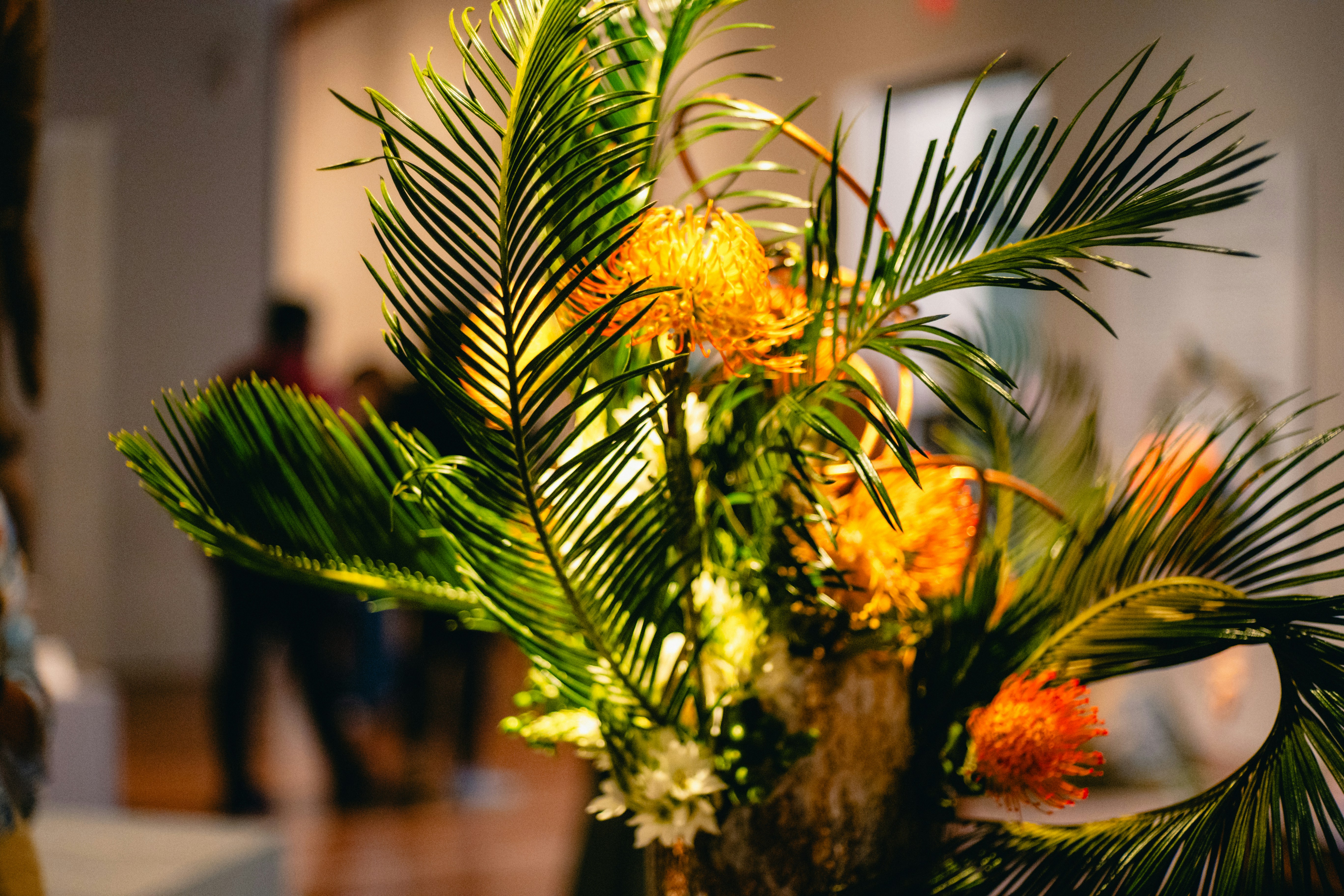 structured floral arrangement with tropical leaves