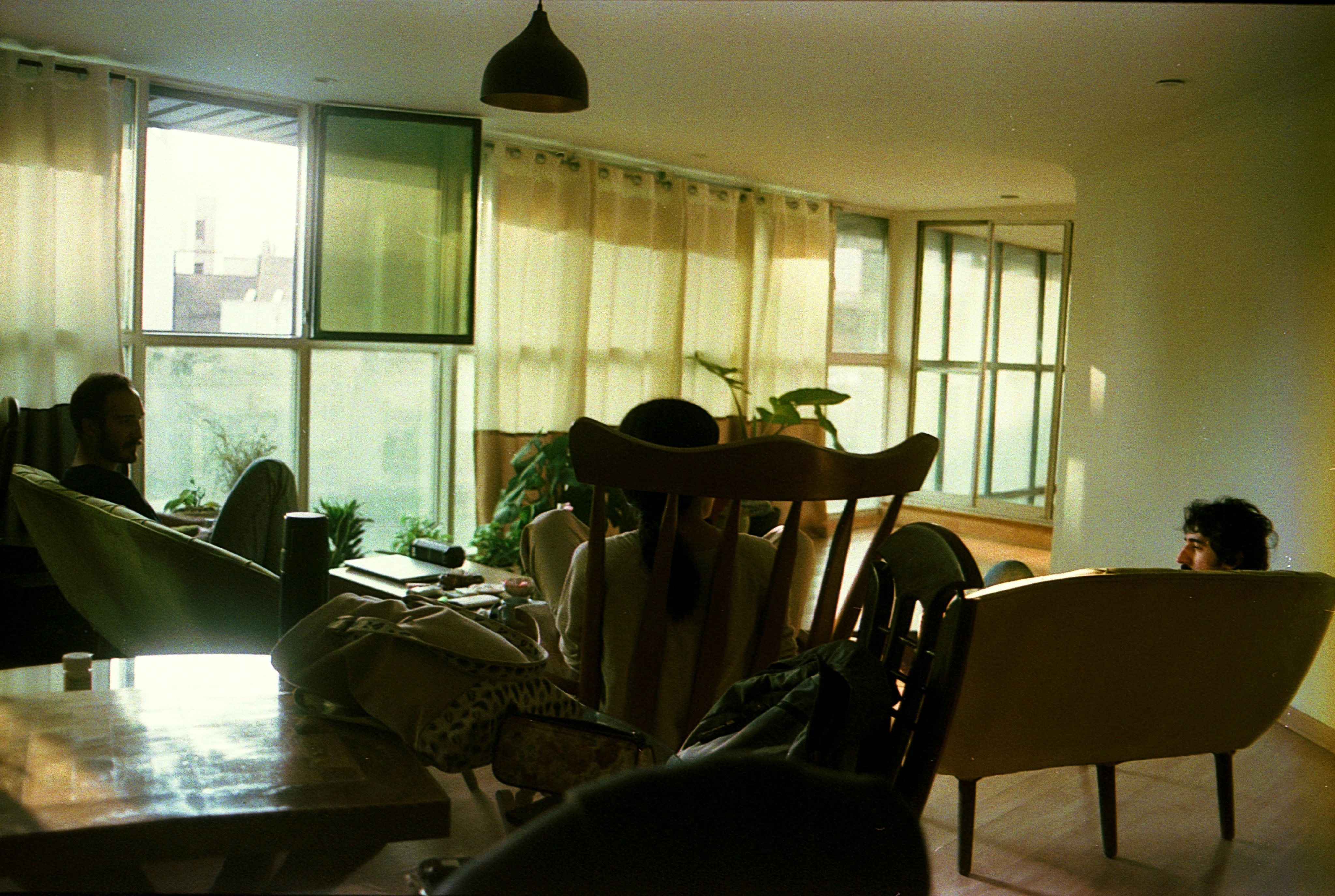 A happy family relaxing in their spotless home. The living room is bright, clean, and organized. - emergency cleaning denver