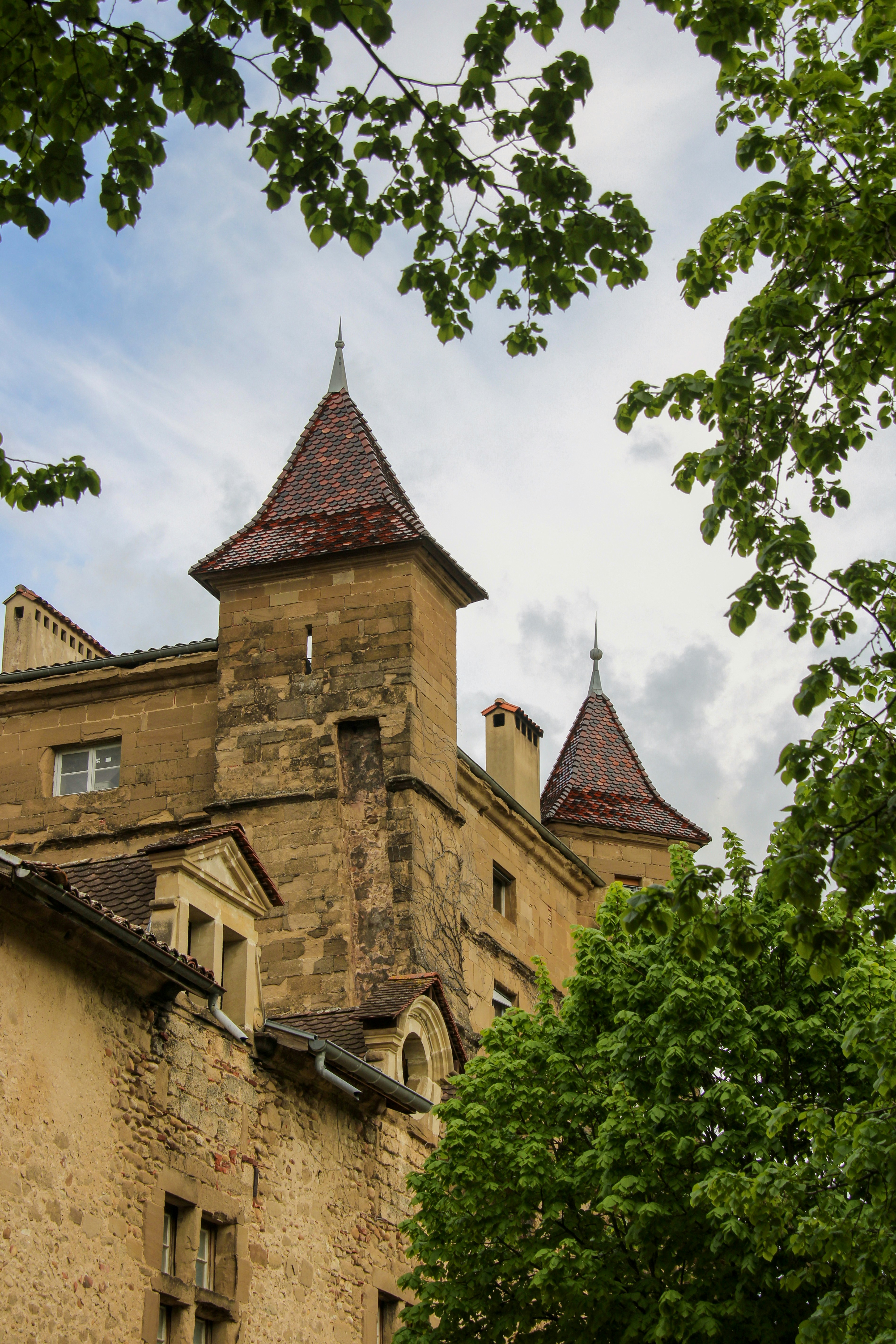 An old castle with two pointy, red-roofed towers.