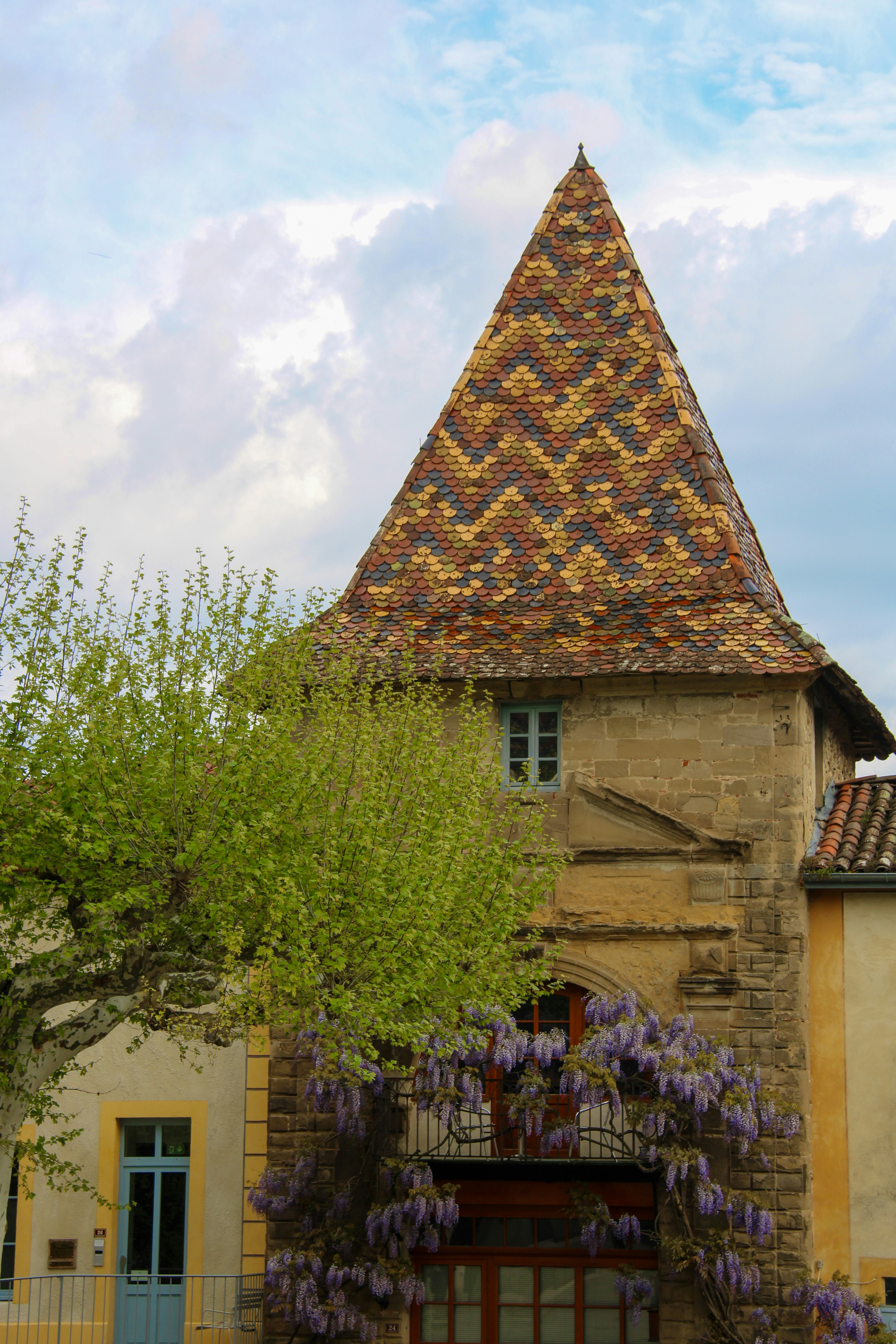 A tower with a unique tiled roof.