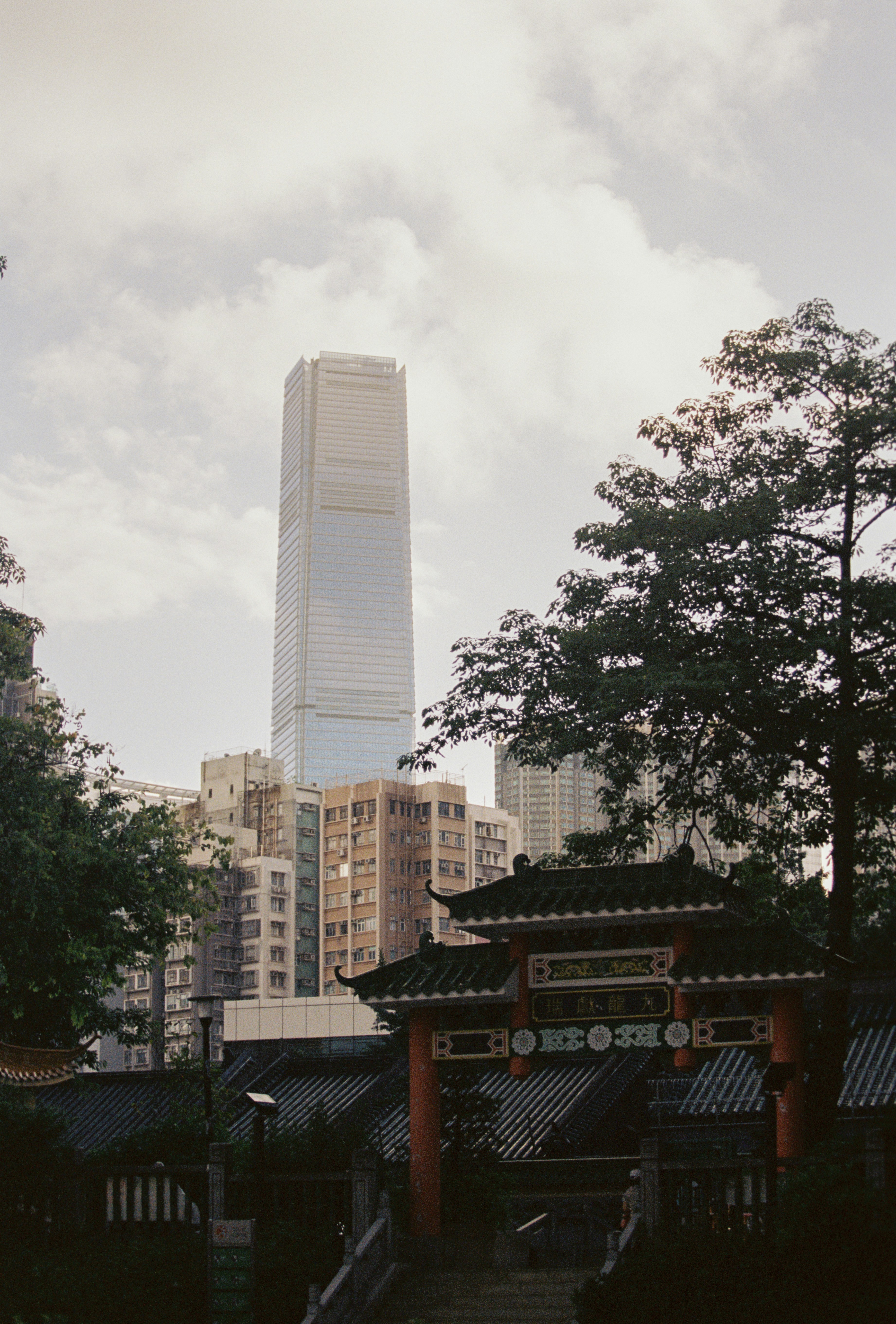 Traditional structure framed by a modern cityscape.