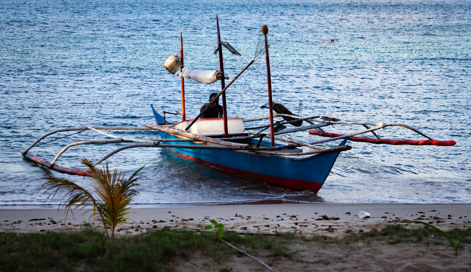 A small fishing boat rests on the shore.