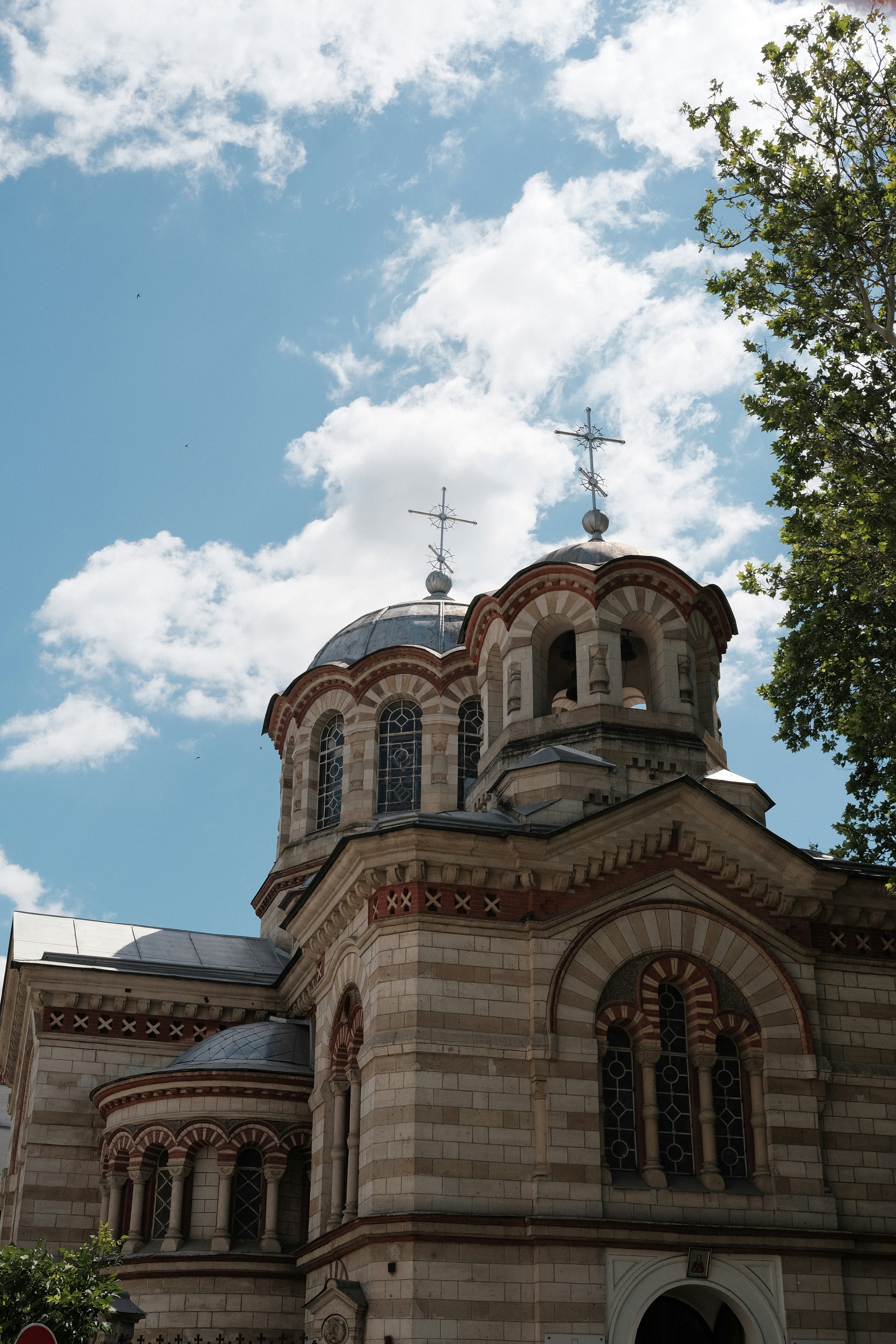 A beautiful church stands beneath a bright blue sky.