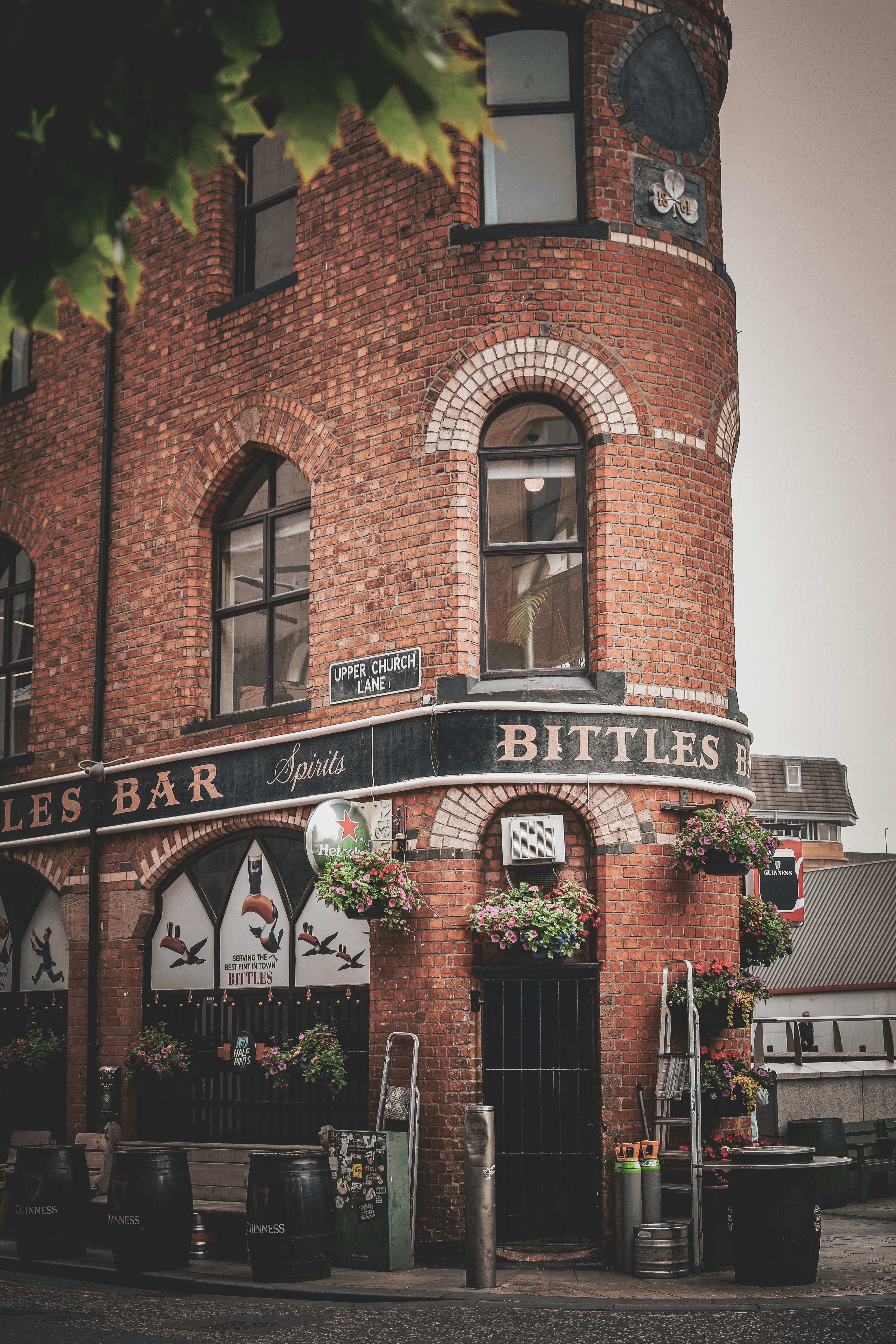 An old, brick building with a bar sign.