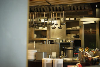 Kitchen utensils hang in a professional kitchen.