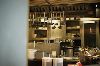 Kitchen utensils hang in a professional kitchen.